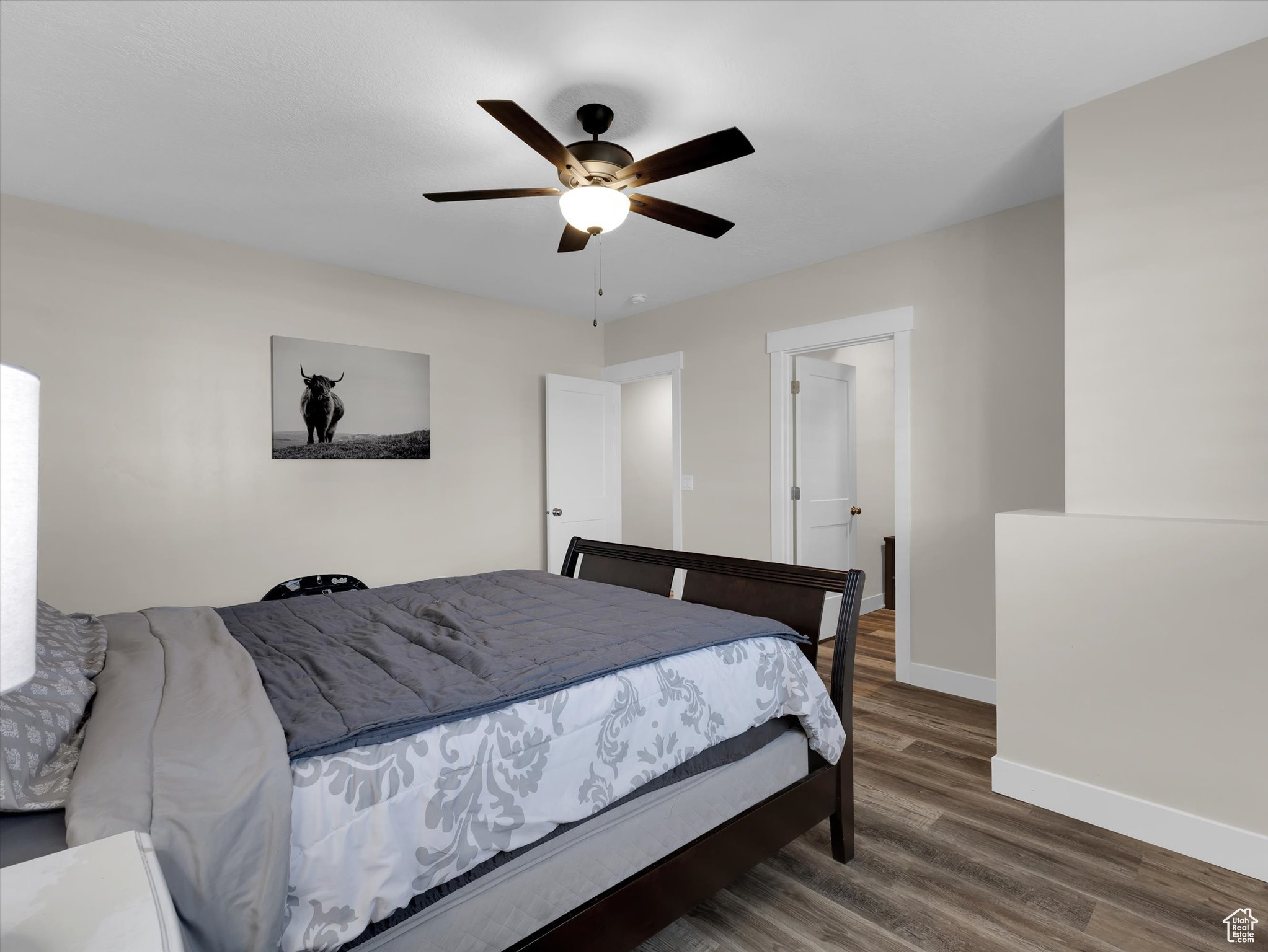 Bedroom #5 with dark wood-type flooring and ceiling fan
