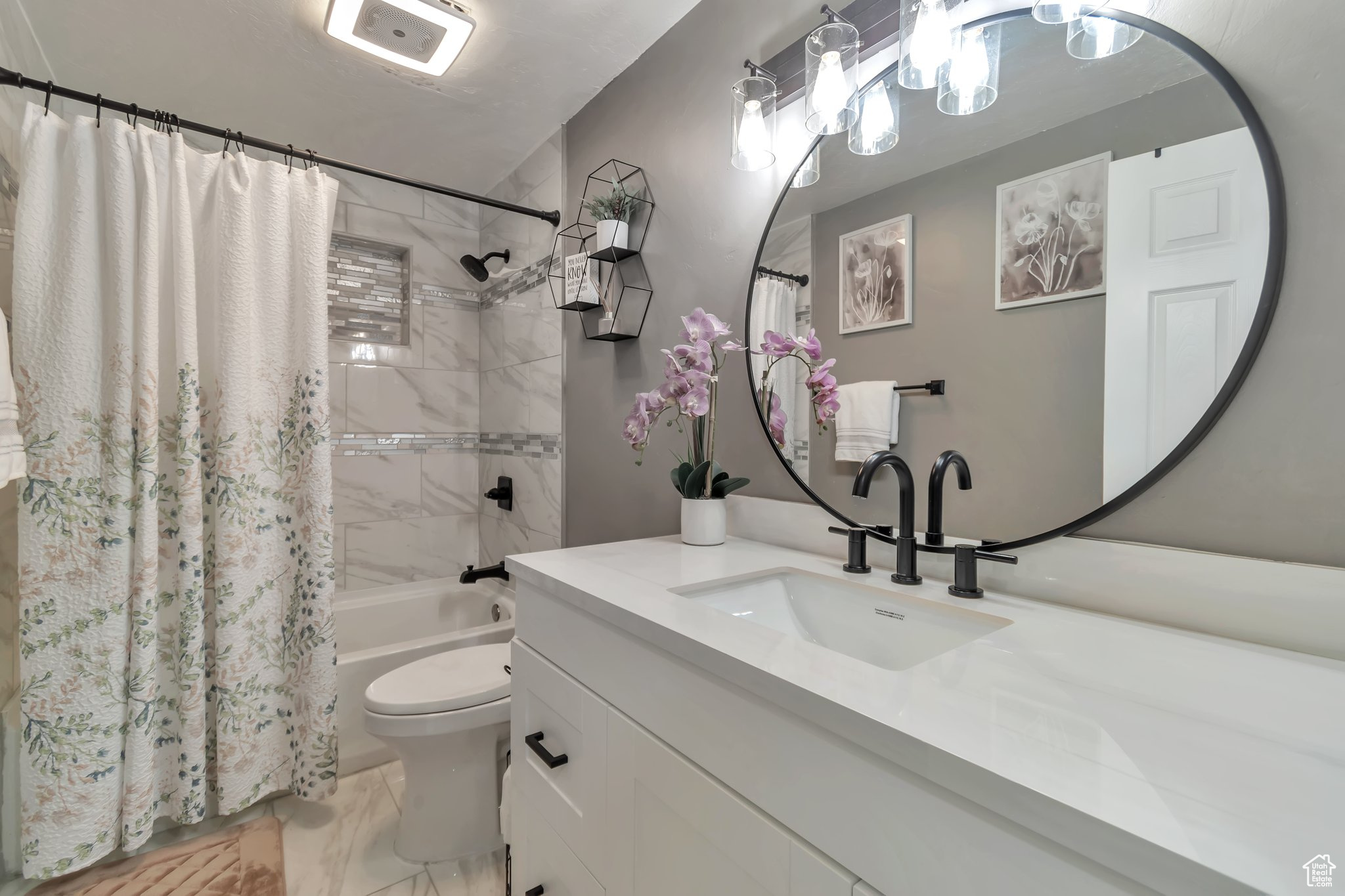 Full bathroom with oversized vanity, shower / bath combination with curtain, tile floors, and toilet