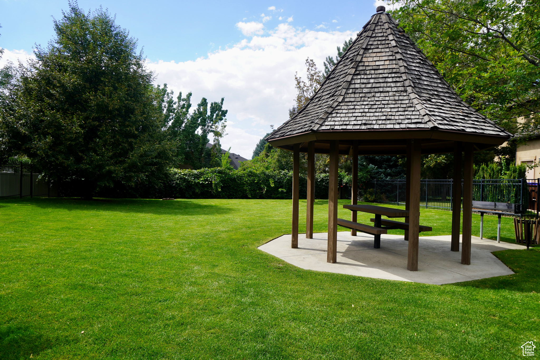 View of park within the gated community with a gazebo and a lawn