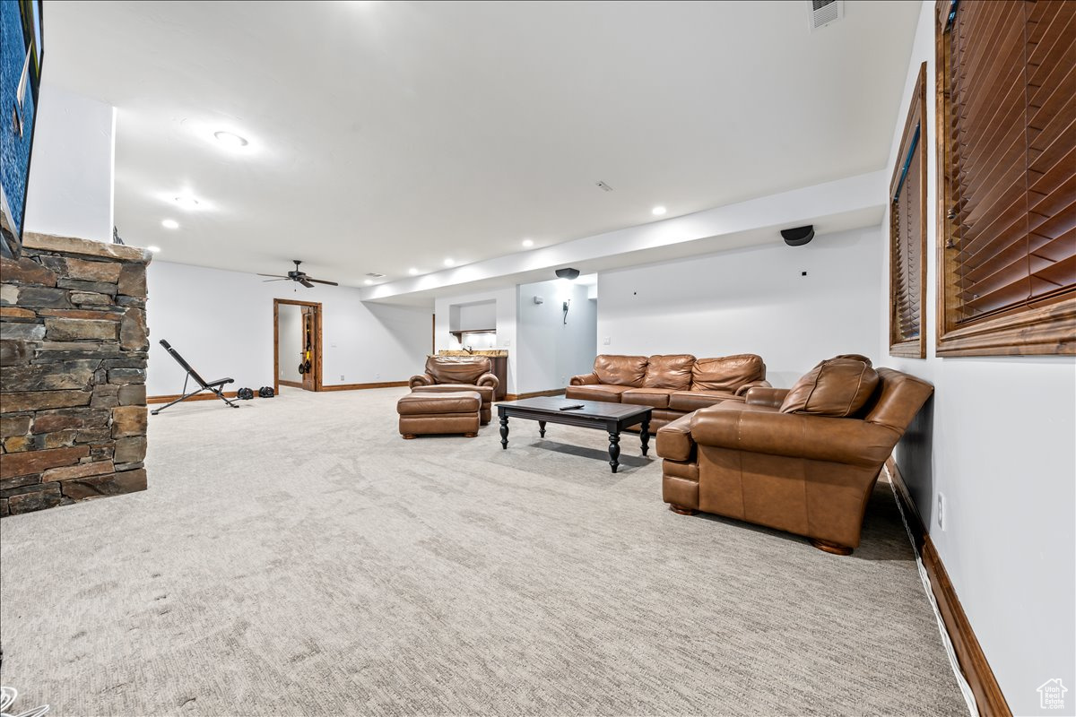 Living room featuring ceiling fan and carpet floors