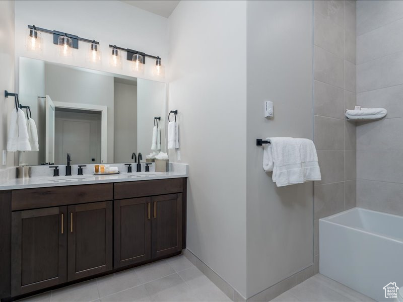 Bathroom with double sink vanity and tile flooring