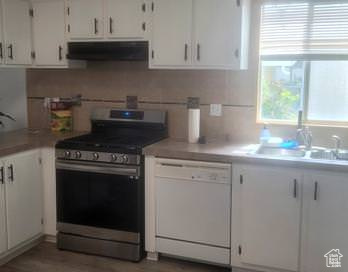 Kitchen with stainless steel range with gas stovetop, dishwasher, white cabinets, and extractor fan