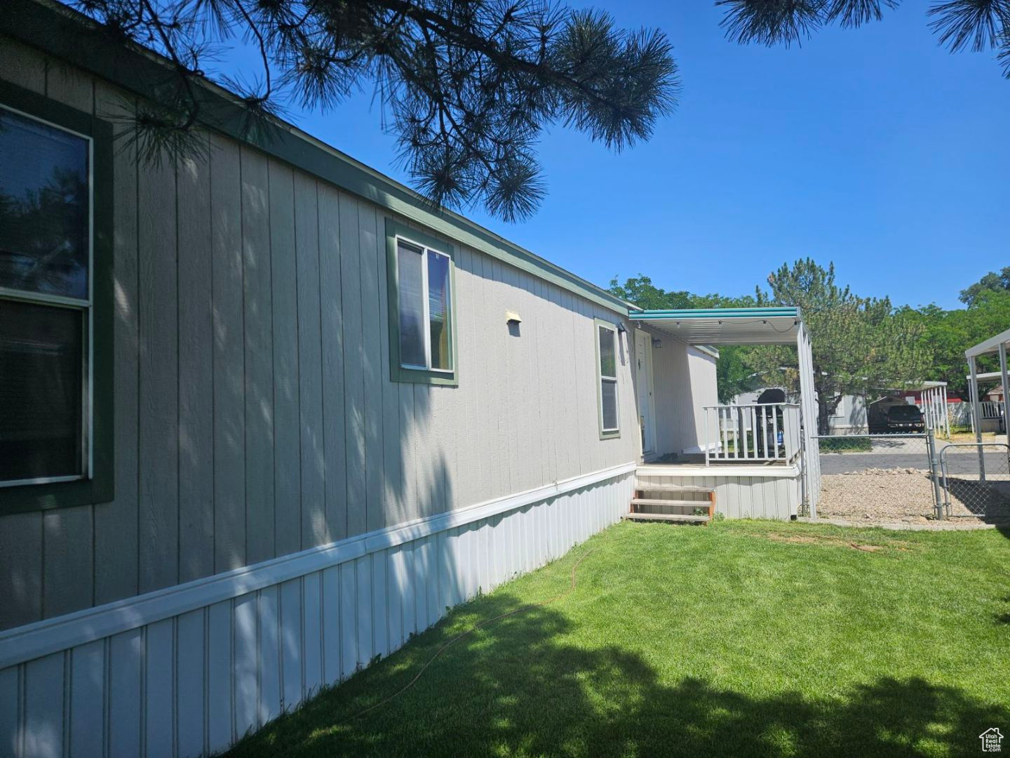 View of side of home featuring a yard