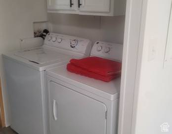 Laundry area with washer and dryer and cabinets