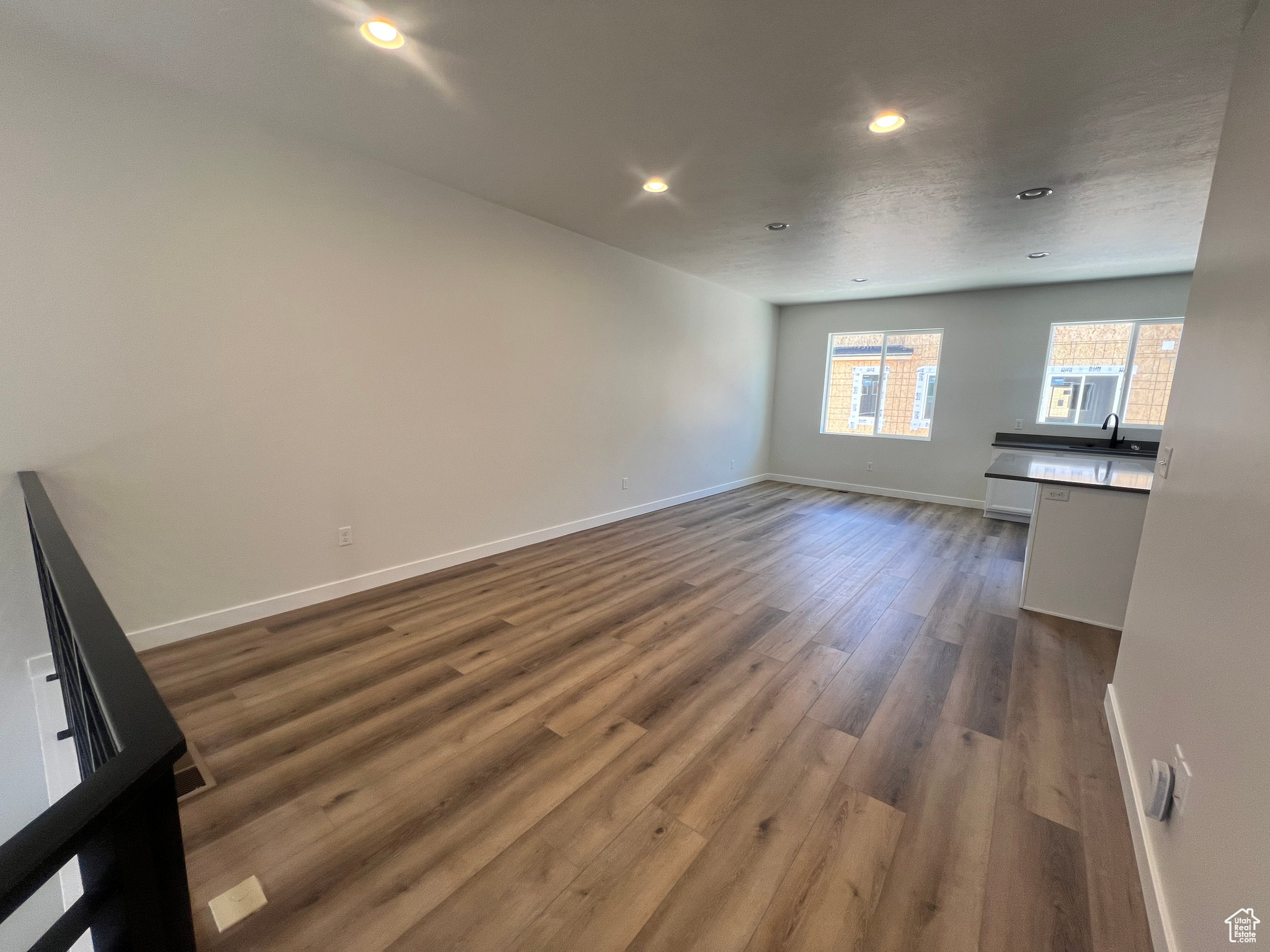 Unfurnished living room with dark wood-type flooring
