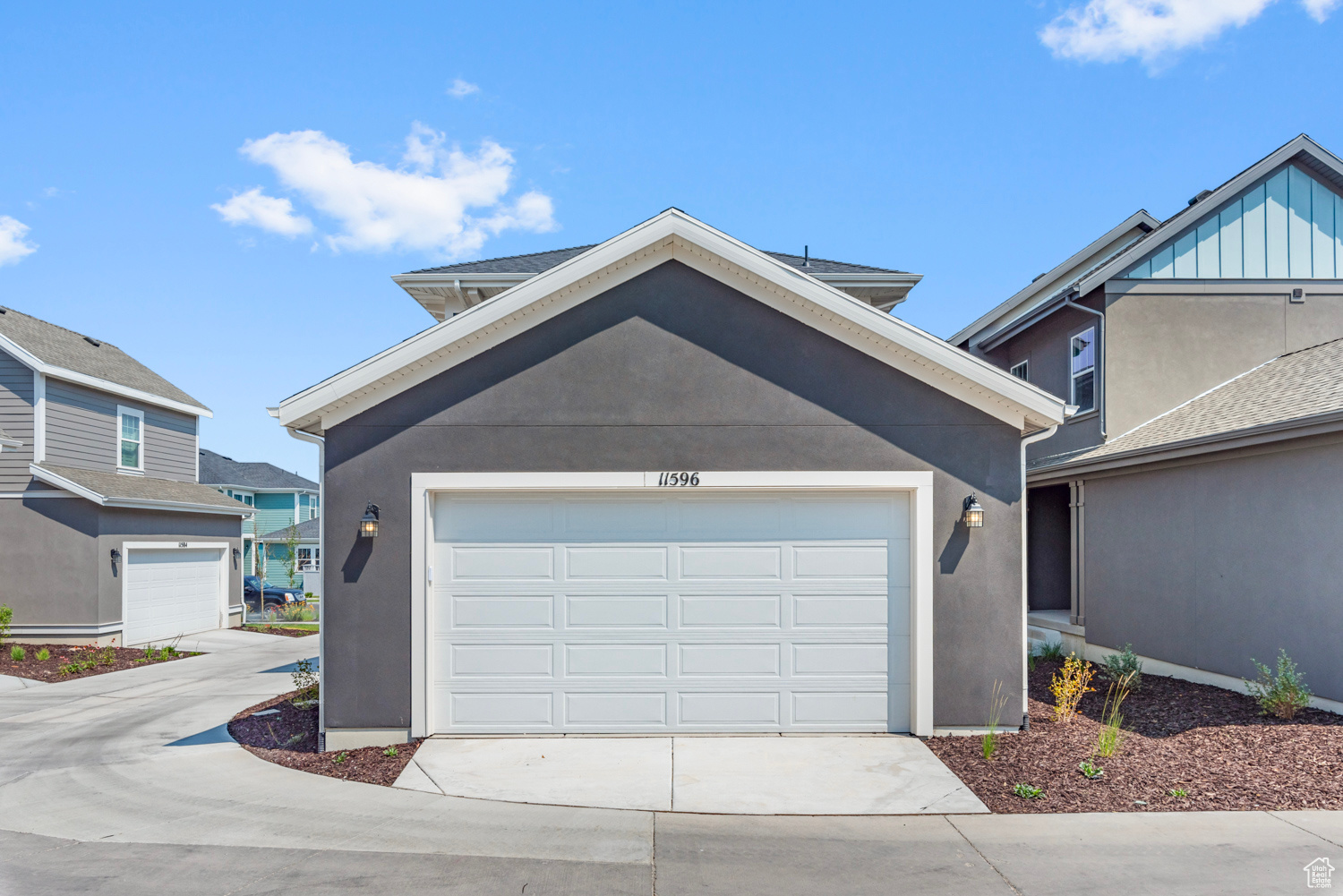 View of rear facade with a garage