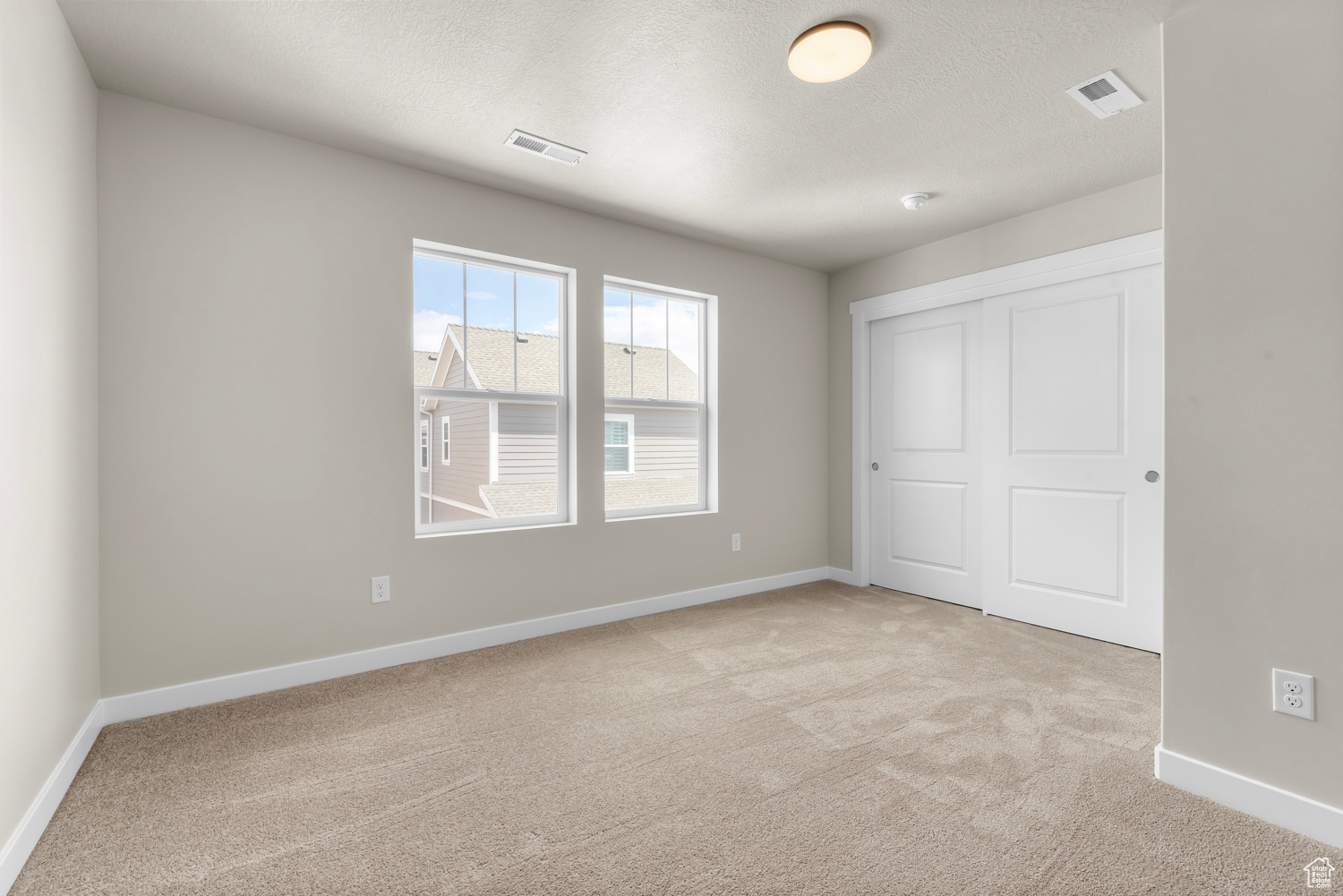 Interior space featuring light colored carpet