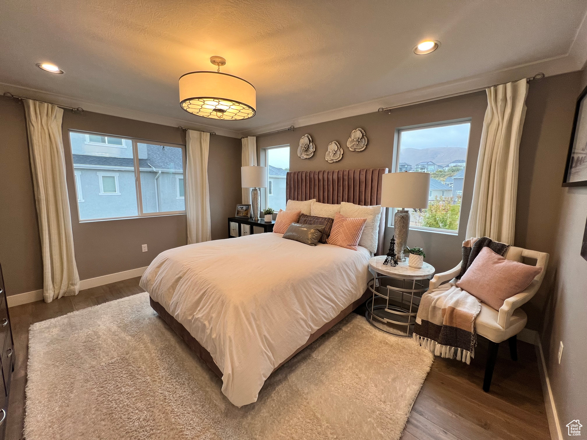 Bedroom featuring hardwood / wood-style floors and multiple windows