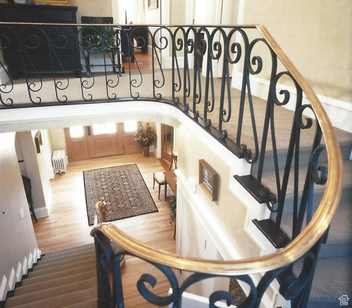 2002 Parade of Homes photo - curved beautiful staircase with decorative arched window on landing, beautiful hardwood floor - example only