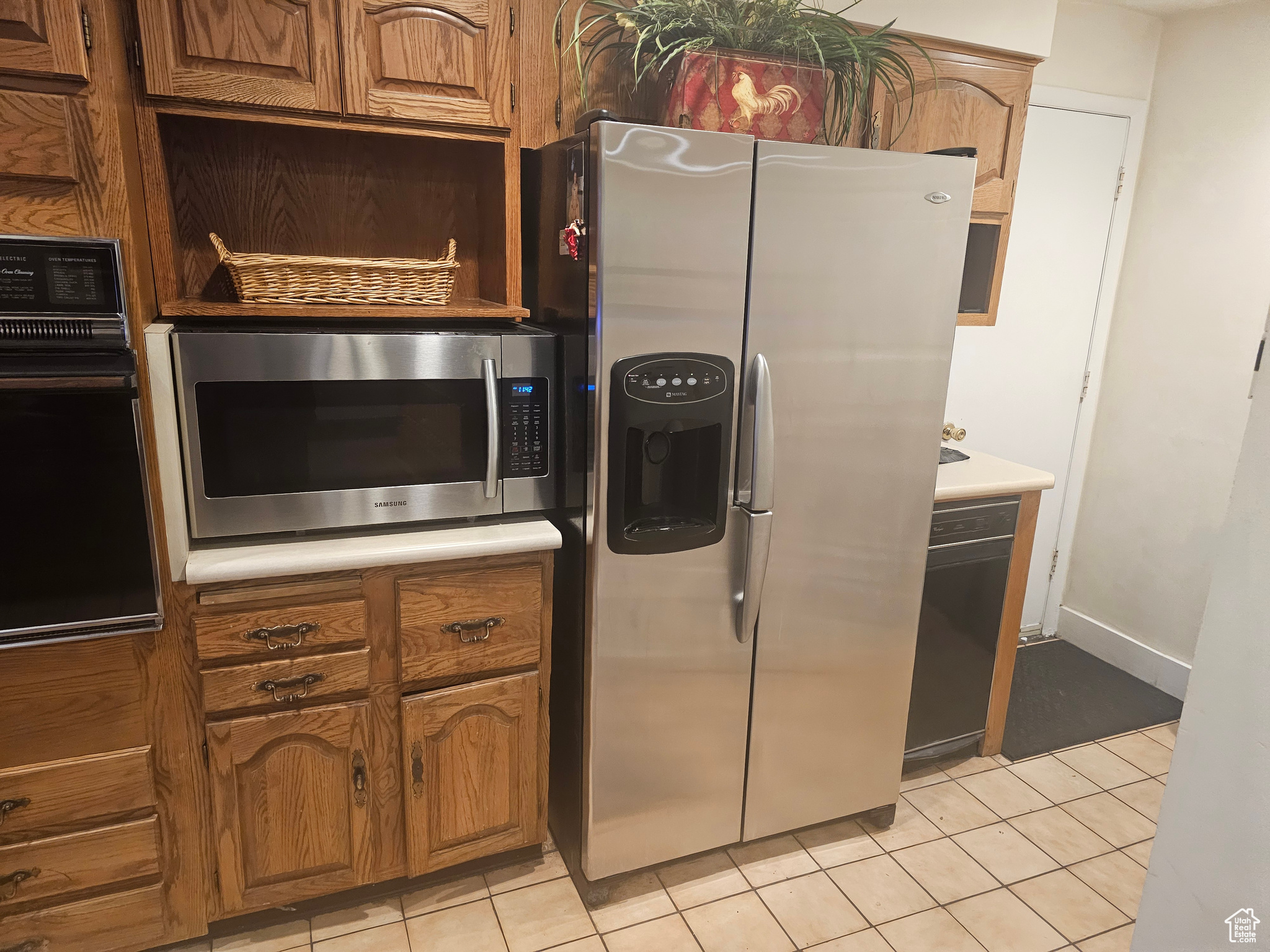 Kitchen featuring stainless steel appliances and light tile floors