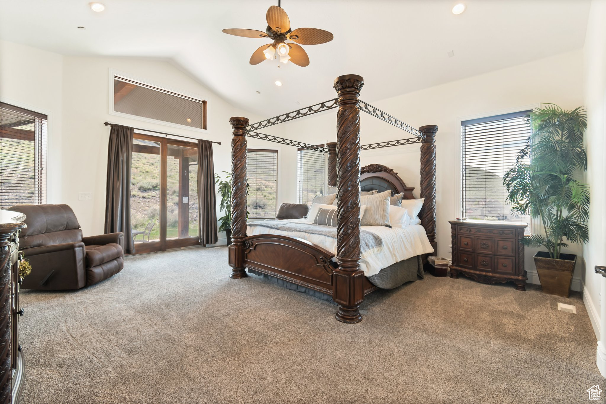 Bedroom with high vaulted ceiling, ceiling fan, access to exterior, and carpet flooring