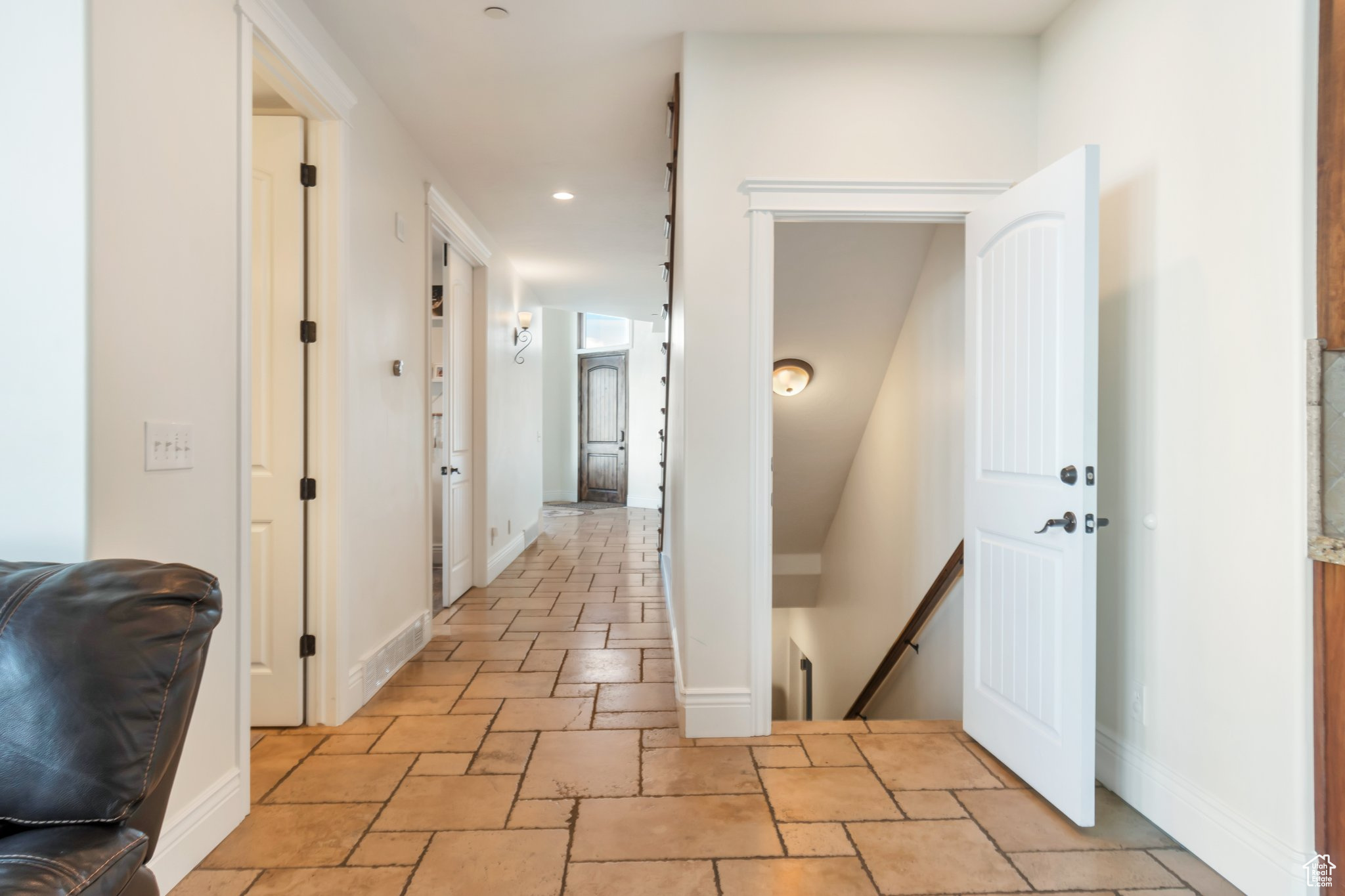 Corridor featuring light tile floors