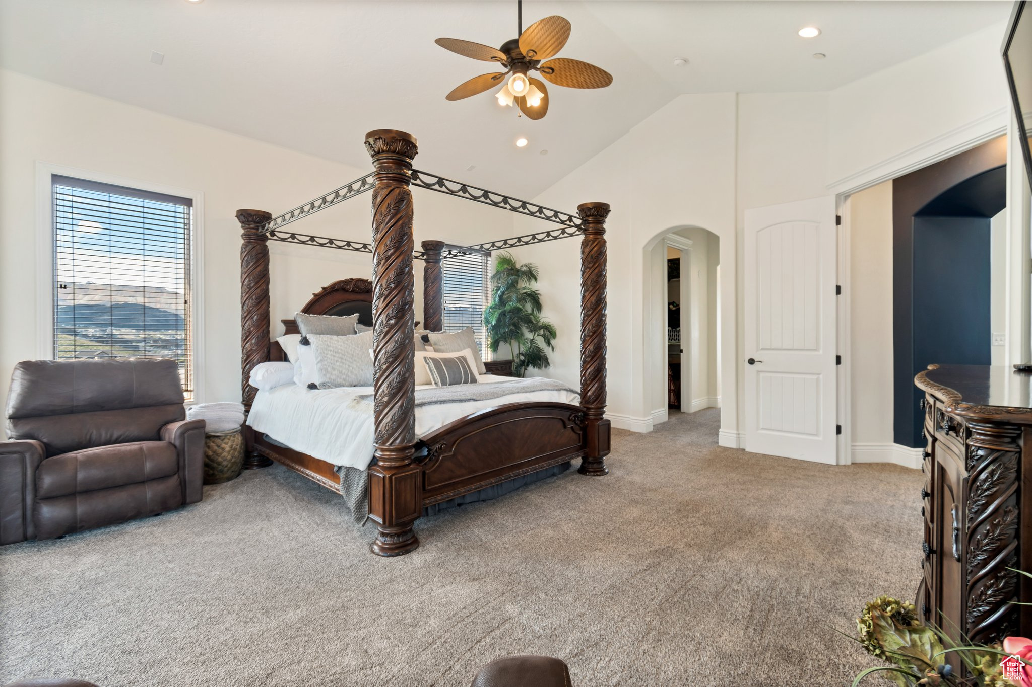 Bedroom with high vaulted ceiling, ceiling fan, and carpet