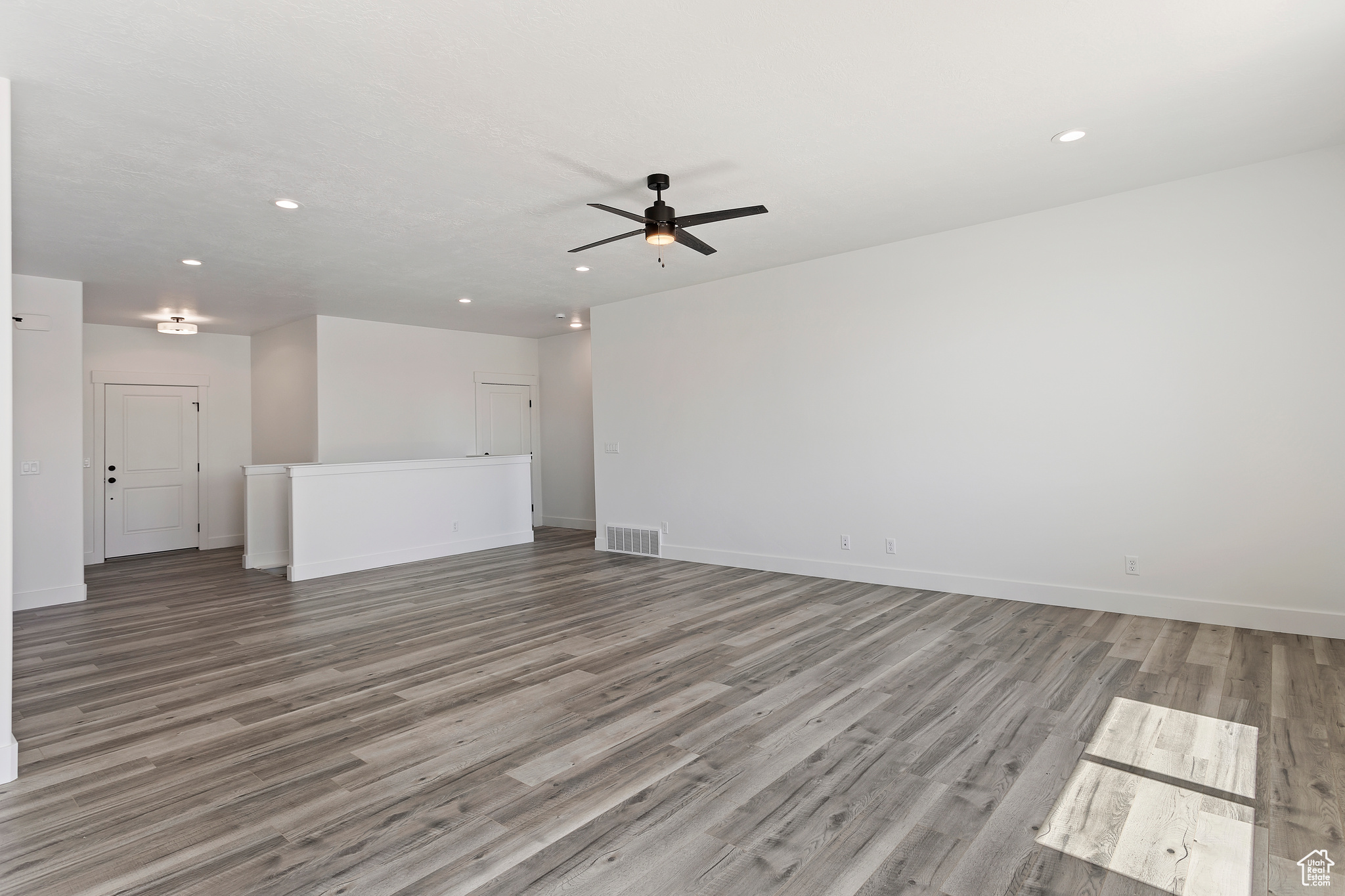 Spare room featuring ceiling fan and hardwood / wood-style floors