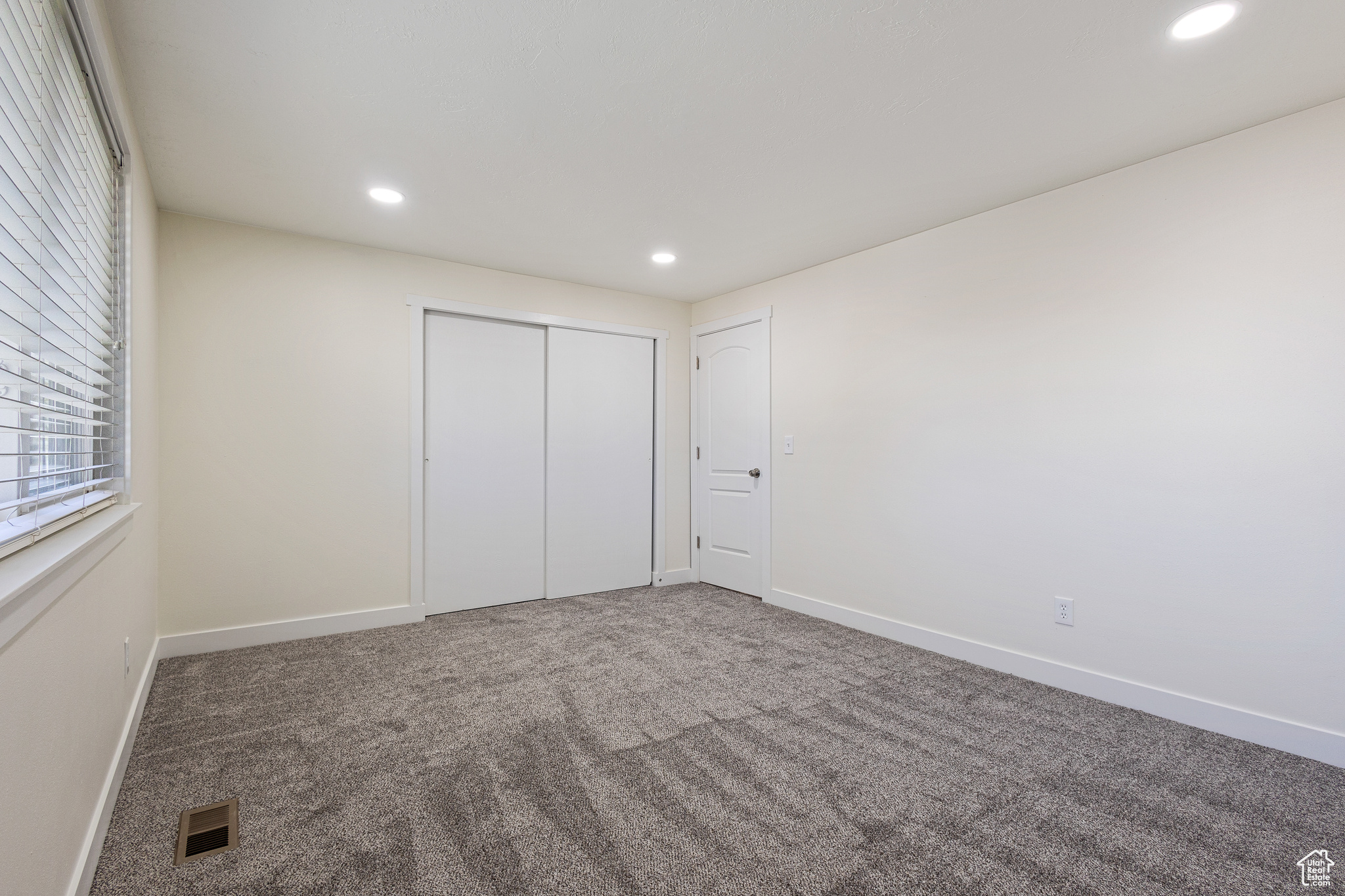 Carpeted Bedroom featuring a textured ceiling and new carpet