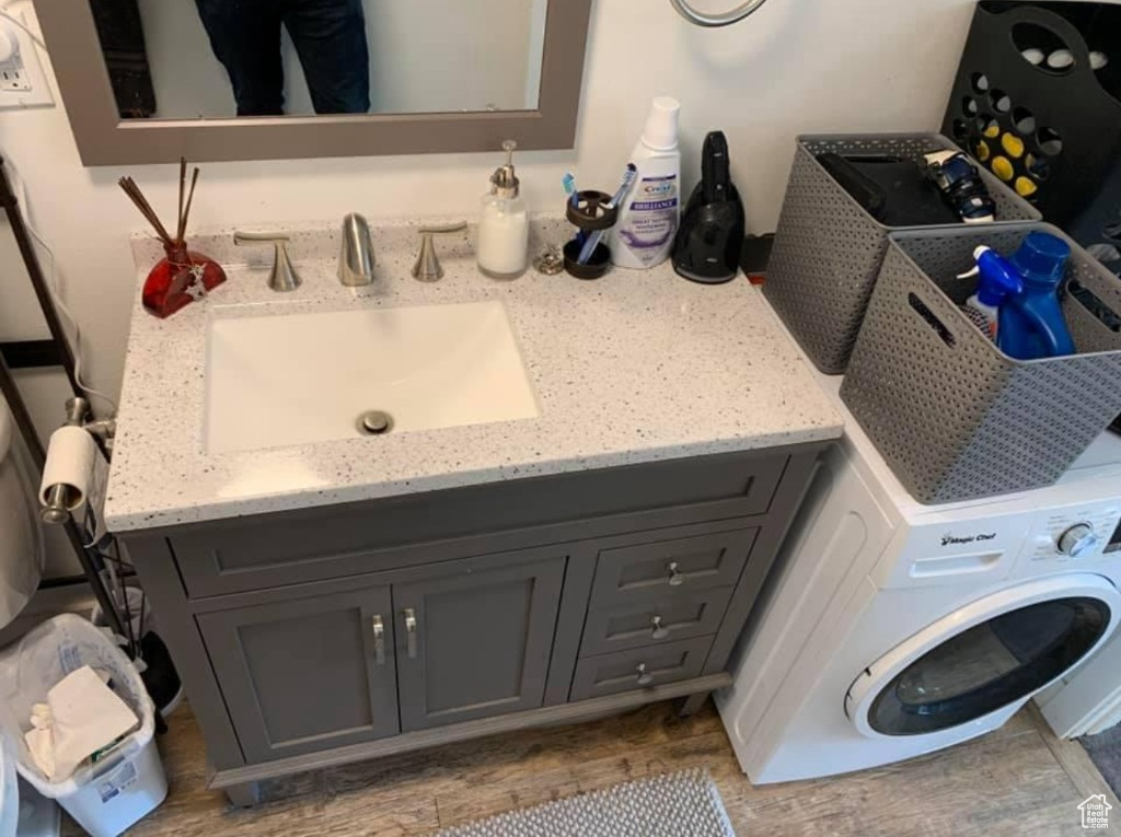 Large single bathroom vanity with in-suite washer/dryer combo