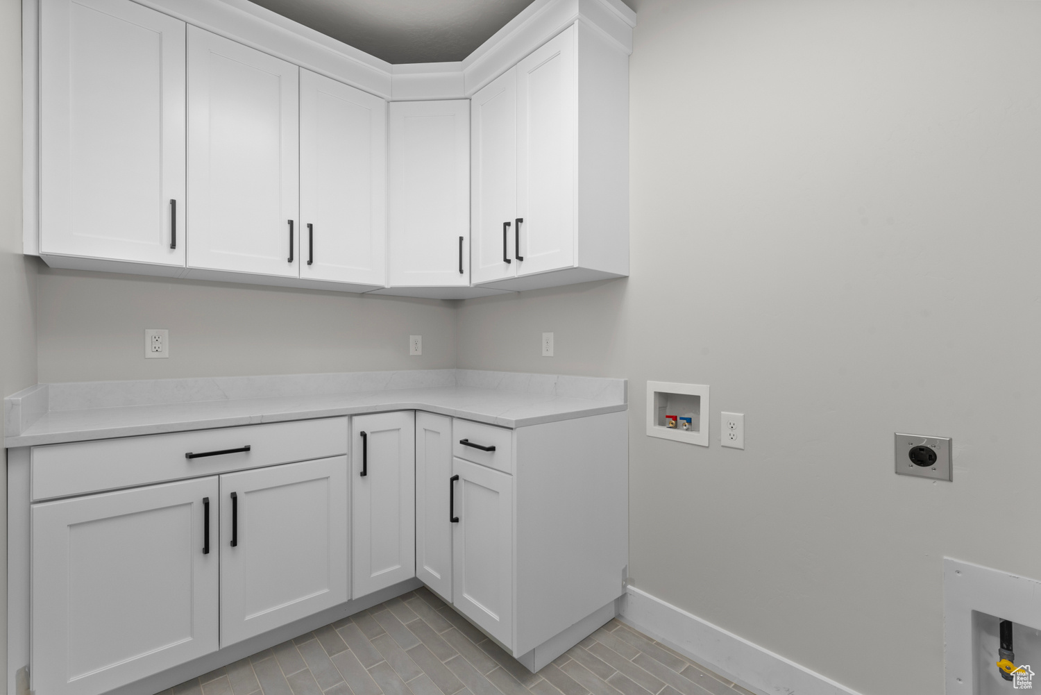 Laundry room featuring cabinets, hookup for an electric dryer, and hookup for a washing machine