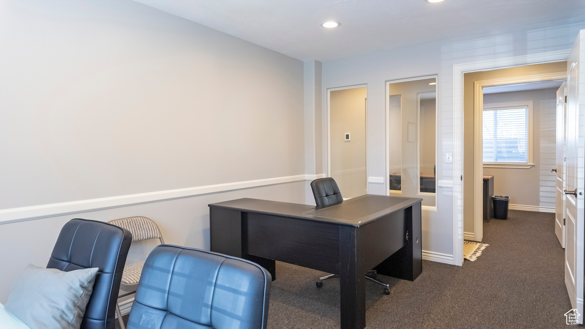 Office area with dark carpet