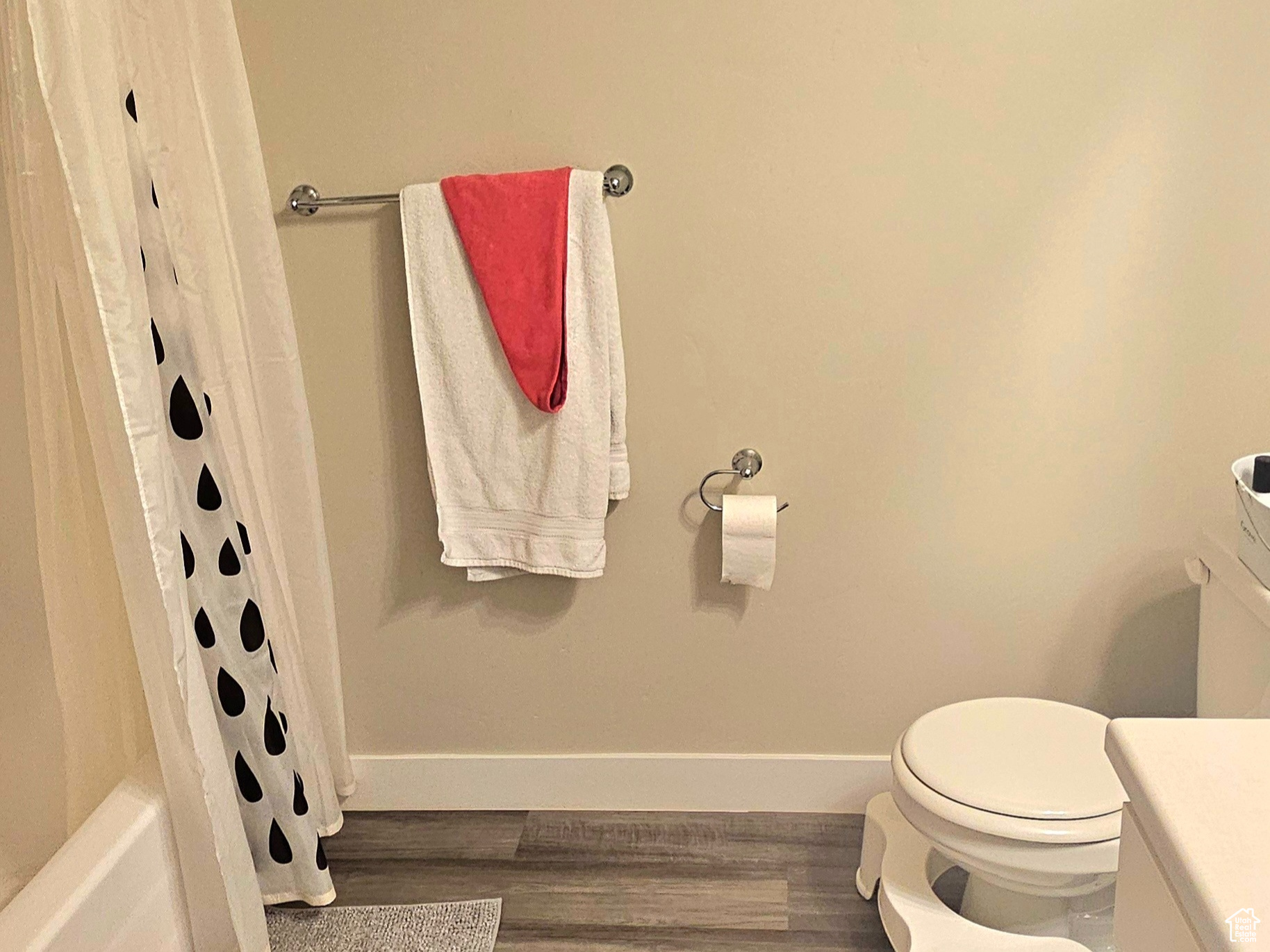 Full bathroom #2 featuring shower / bath combo, vanity, hardwood / wood-style flooring, and toilet