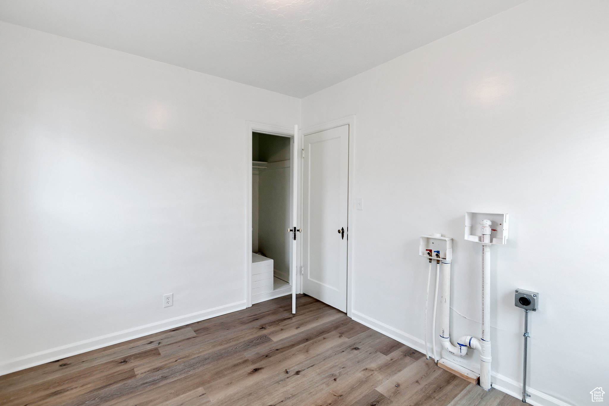 Bedroom/laundry/office  featuring hardwood / wood-style floors