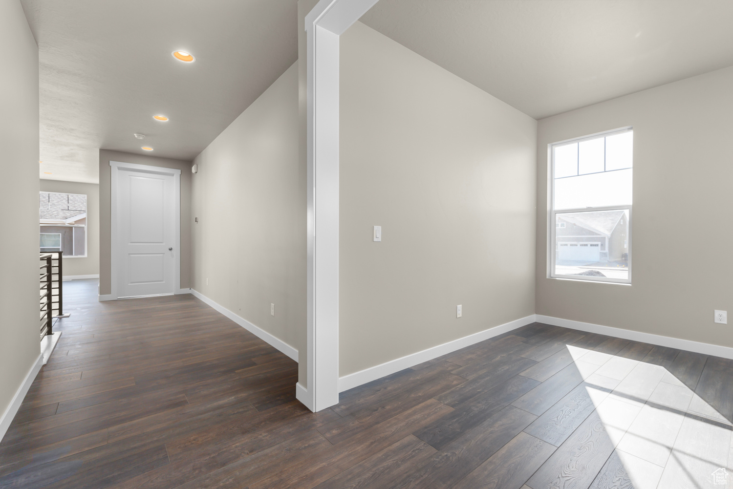 Hall with dark hardwood / wood-style floors