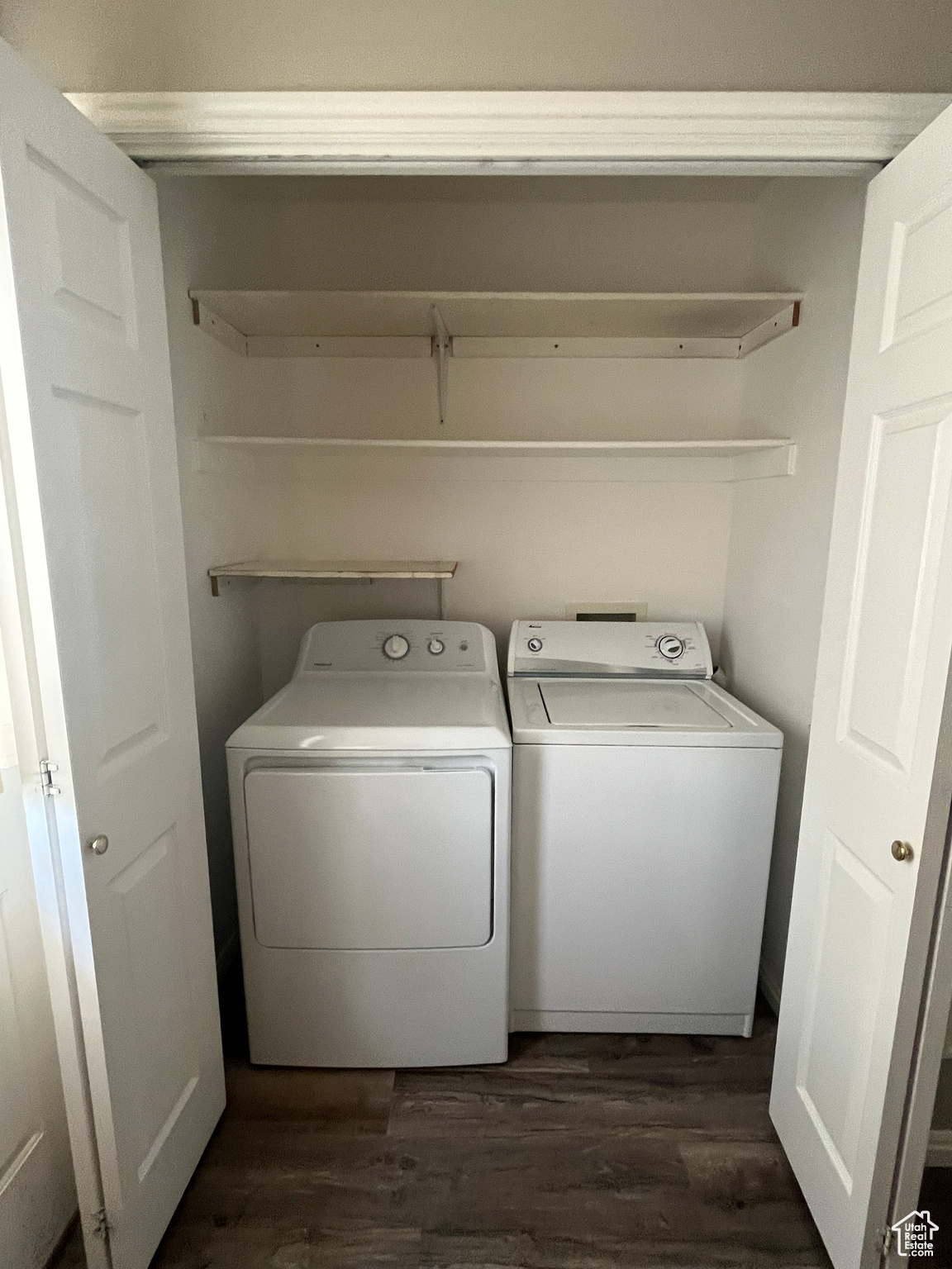 Clothes washing area featuring dark hardwood / wood-style flooring and separate washer and dryer