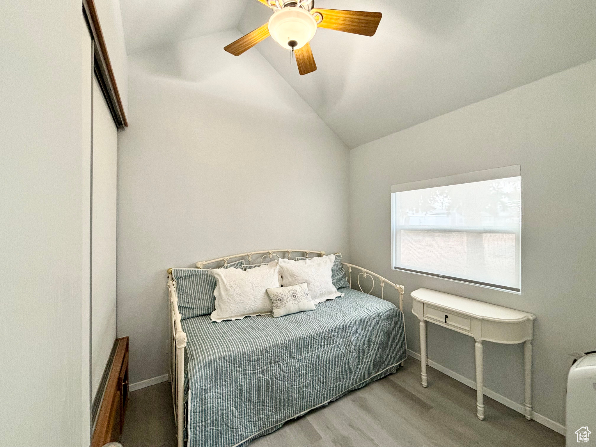 Bedroom features a full wall length closet, built ins, and lofty vaulted ceilings!