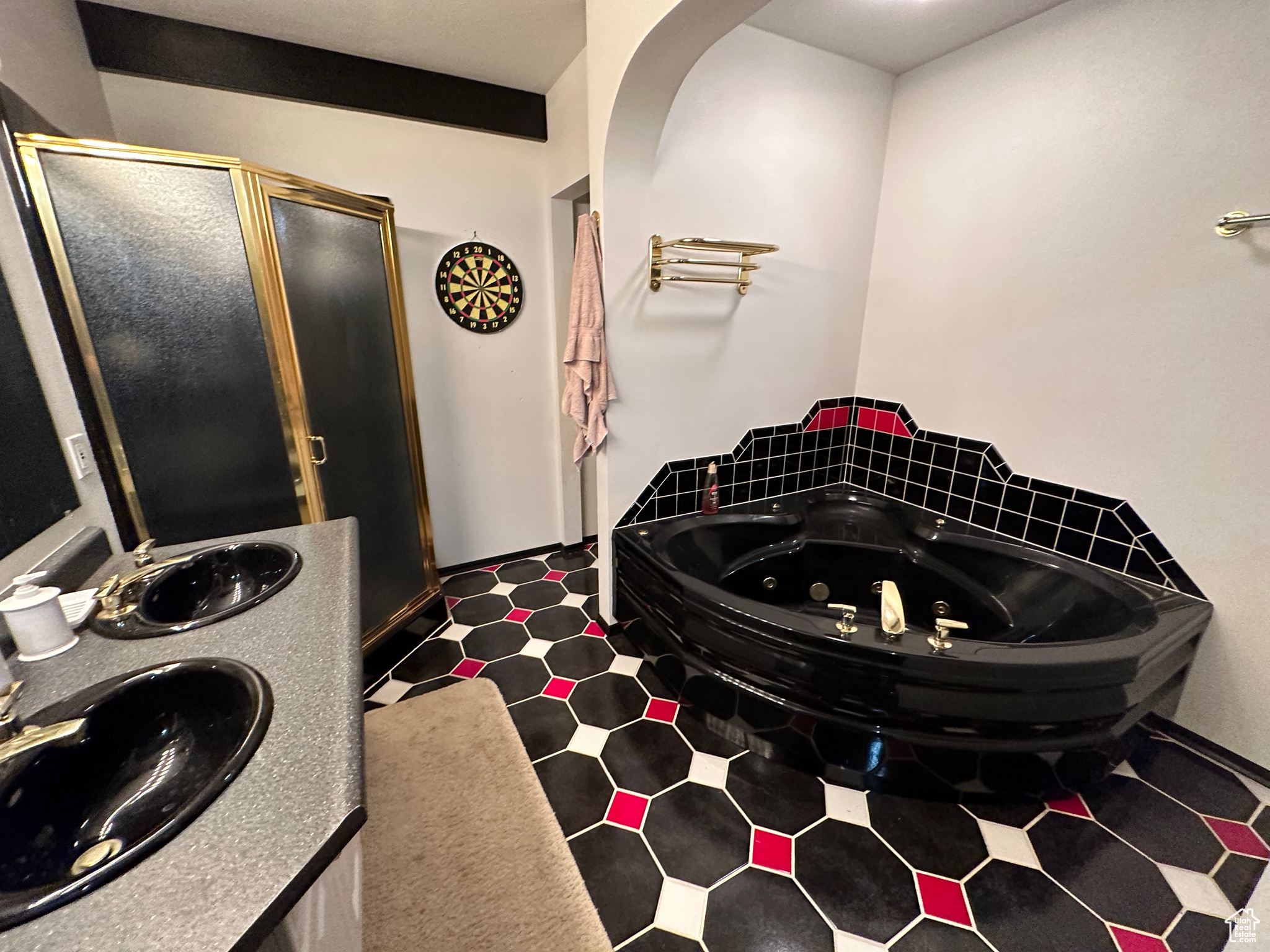 Bathroom featuring tile flooring, double vanity, and separate shower and tub