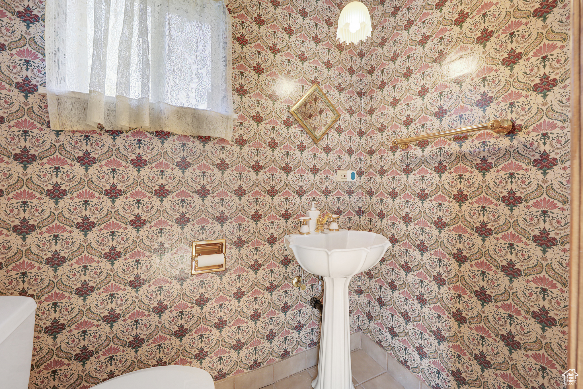 Guest Half Bathroom featuring tile floors and toilet