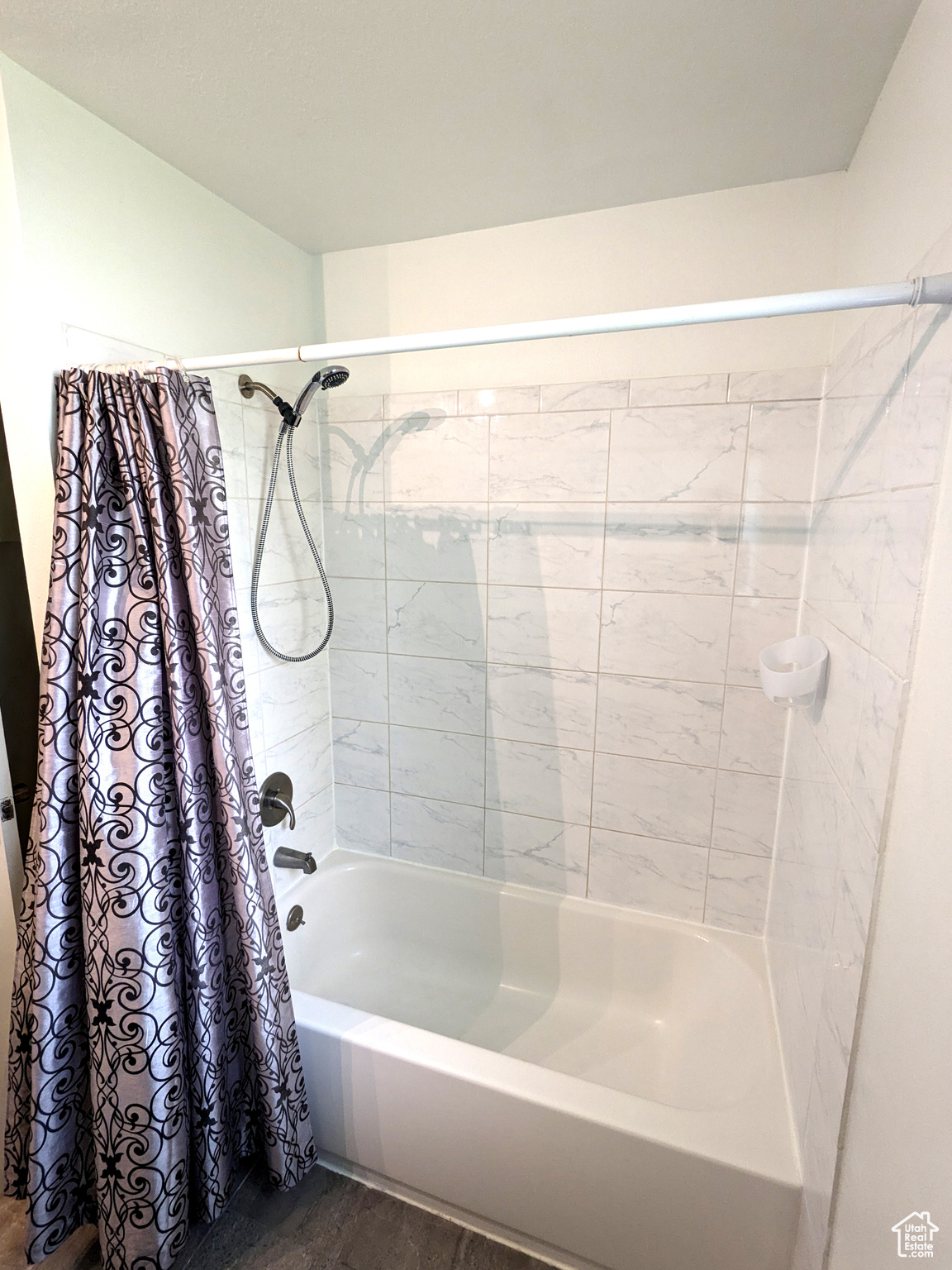 Bathroom featuring hardwood / wood-style flooring and shower / tub combo with curtain