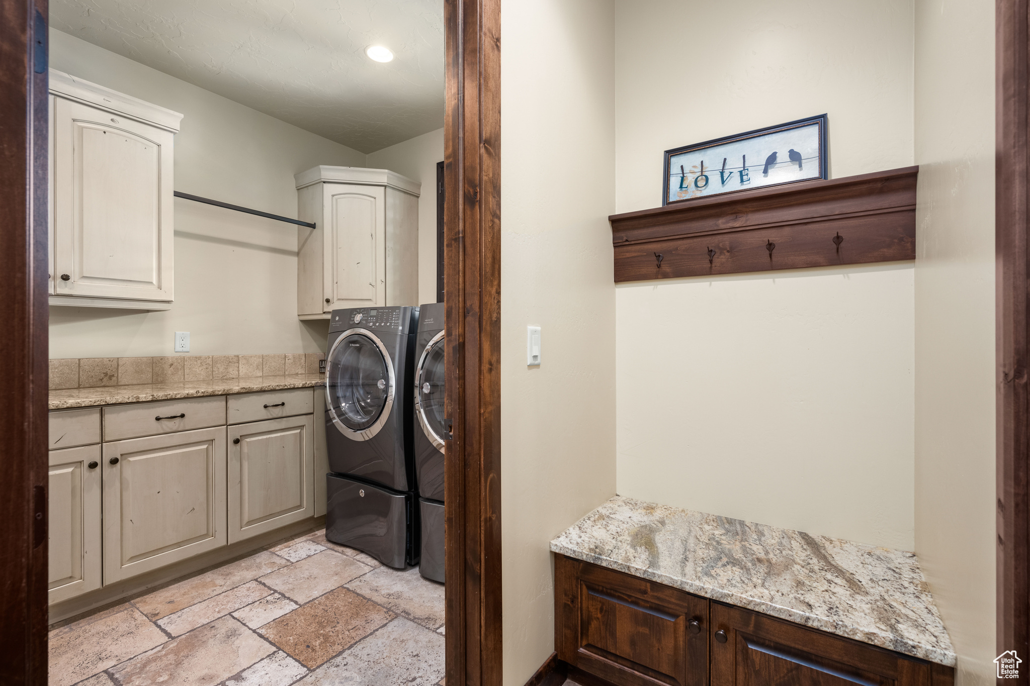 Laundry room with cabinets, independent washer and dryer, and light tile floors