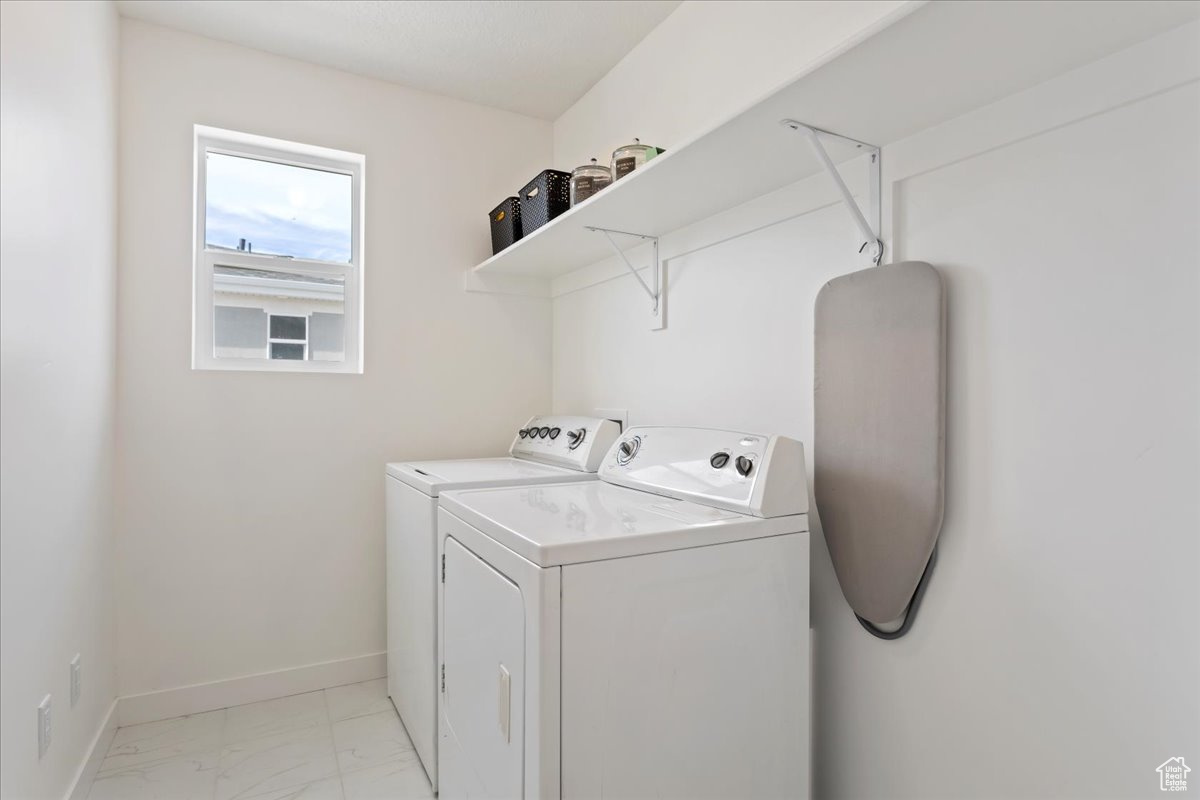 Laundry room with light tile floors