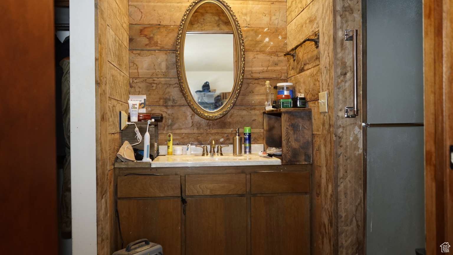 Bathroom featuring vanity and wooden walls
