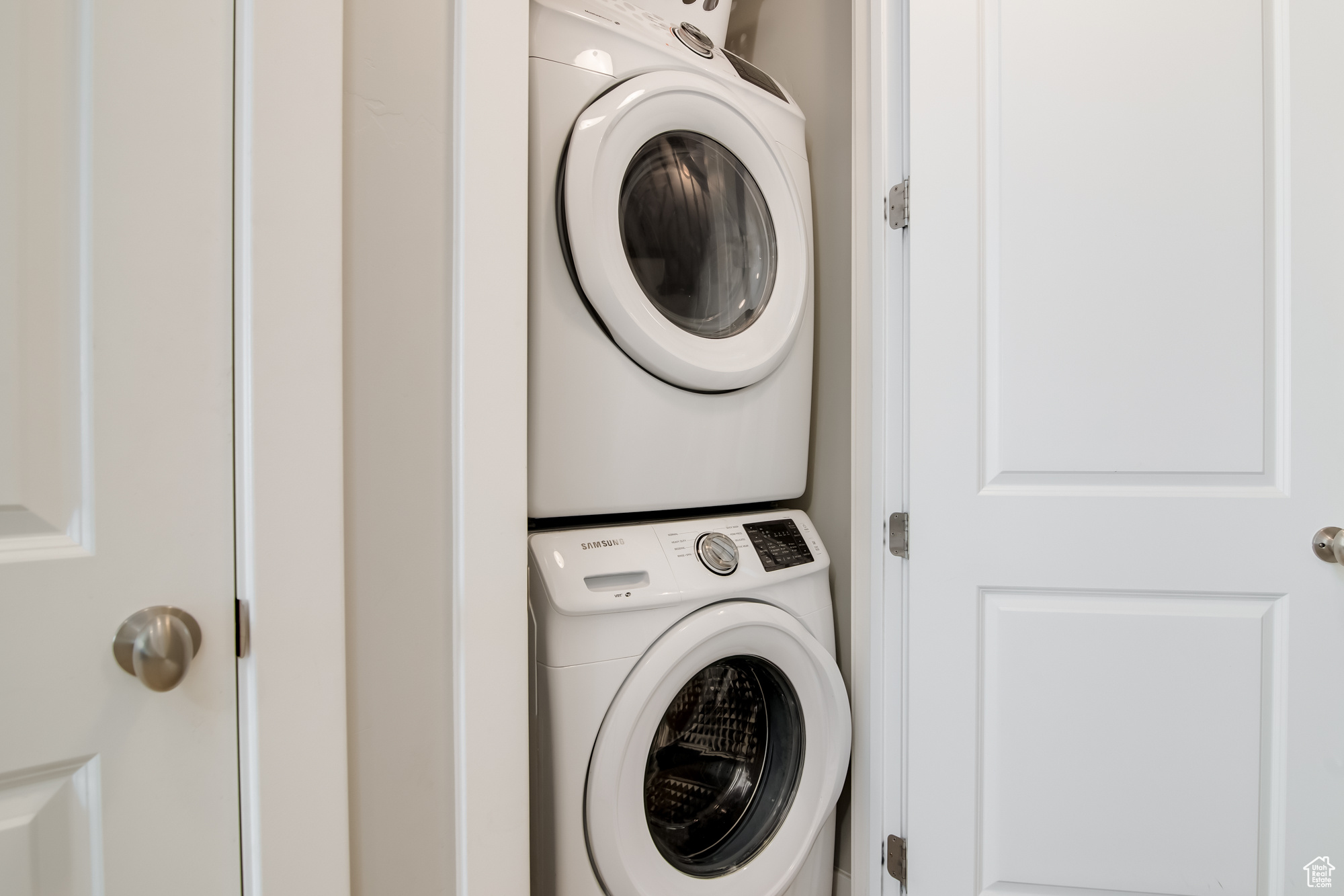 Washroom with stacked washer and dryer