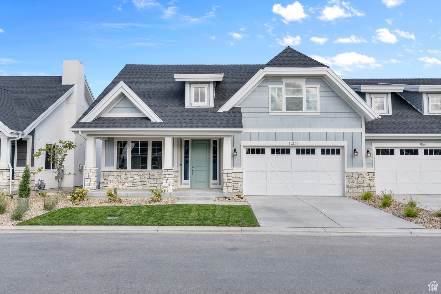 Craftsman inspired home featuring a garage and covered porch