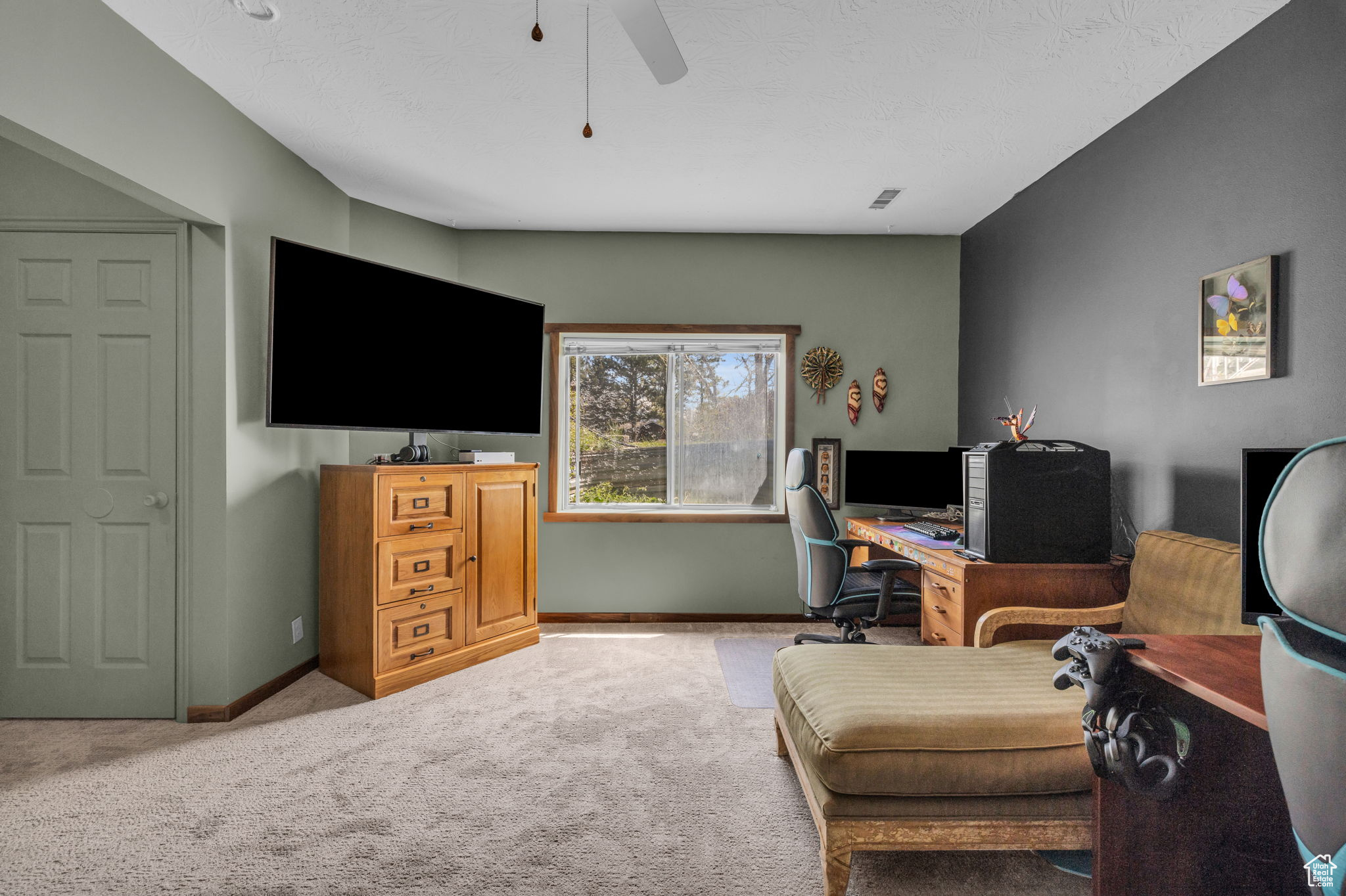 Home office featuring ceiling fan and carpet flooring
