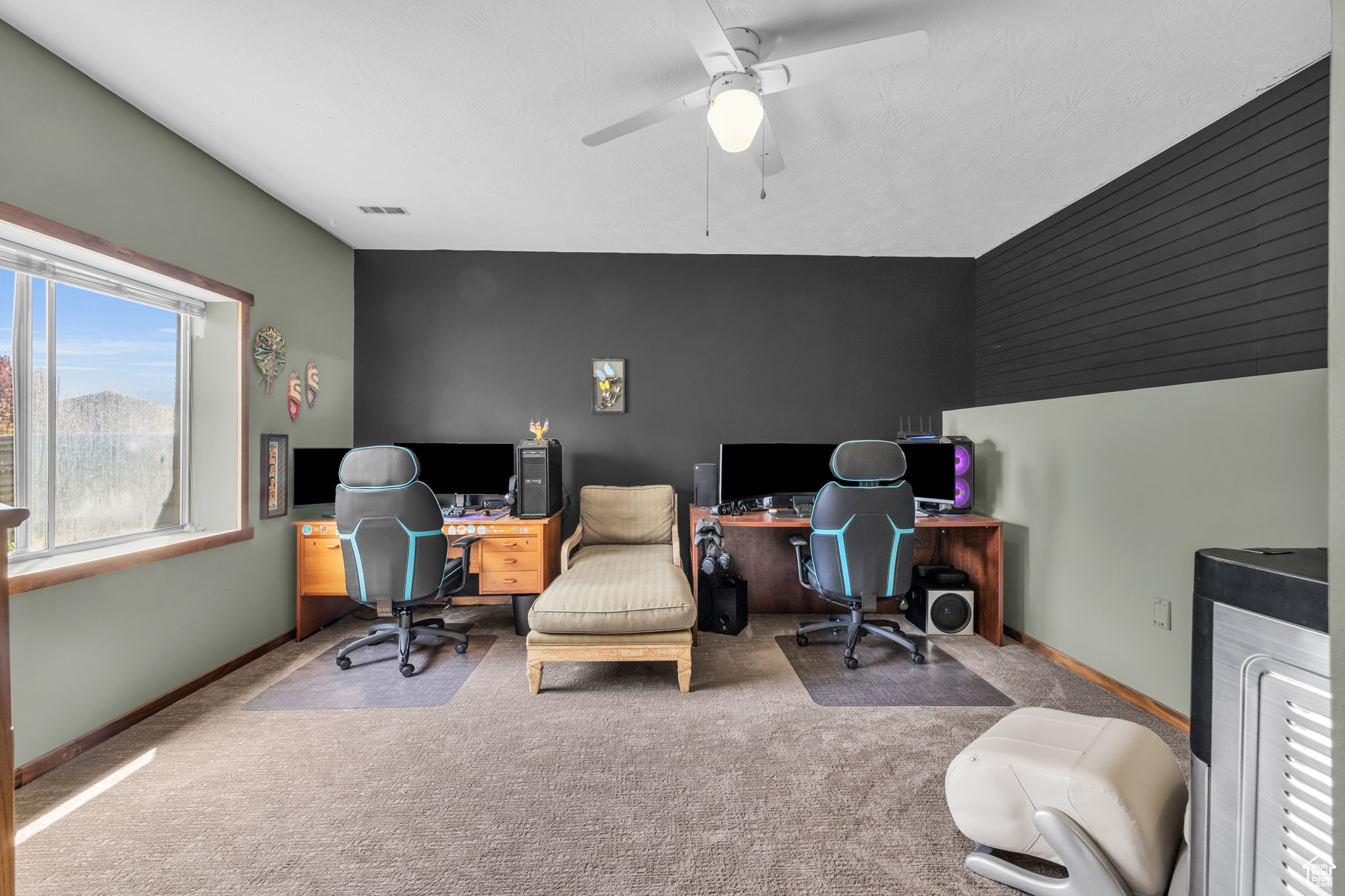 Office area featuring carpet floors and ceiling fan