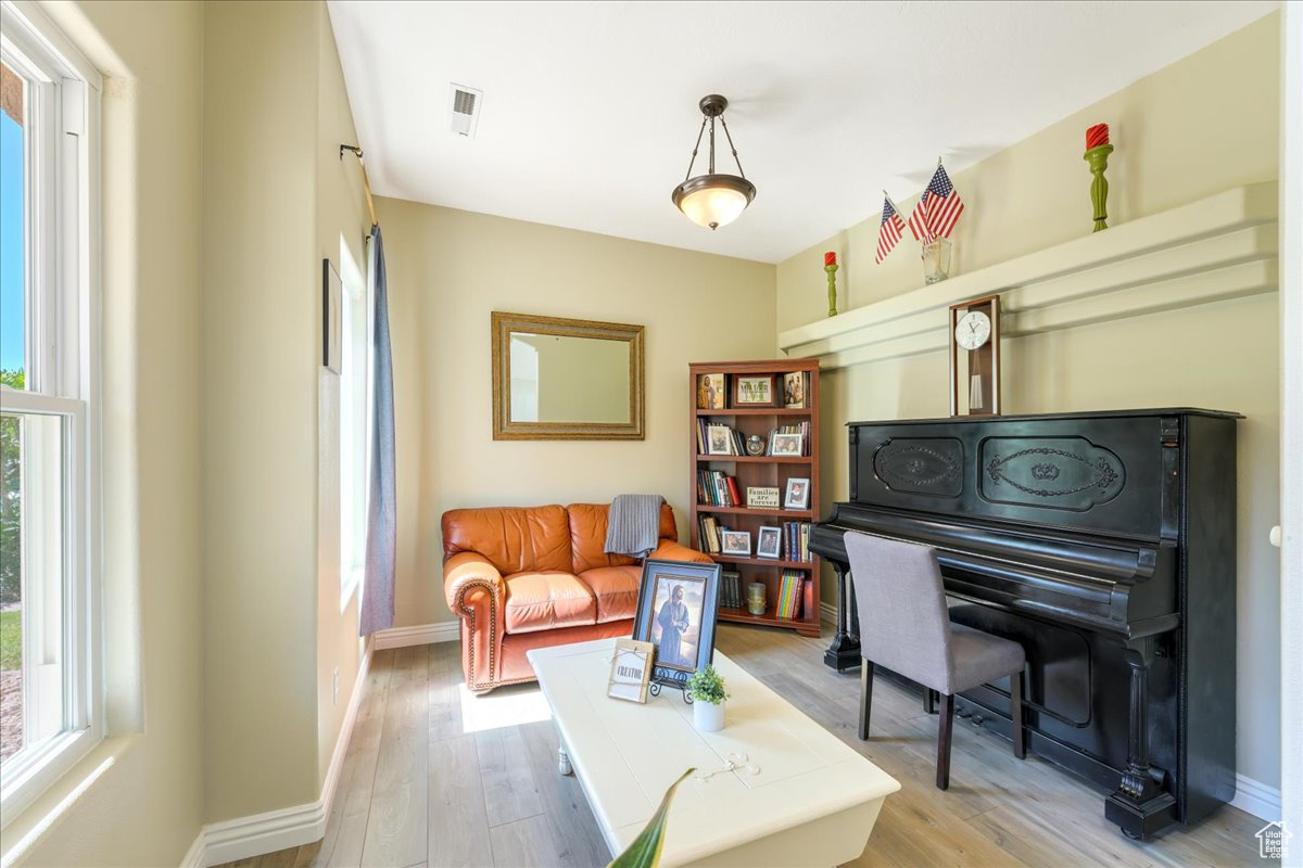 Sitting room featuring hardwood / wood-style floors and plenty of natural light