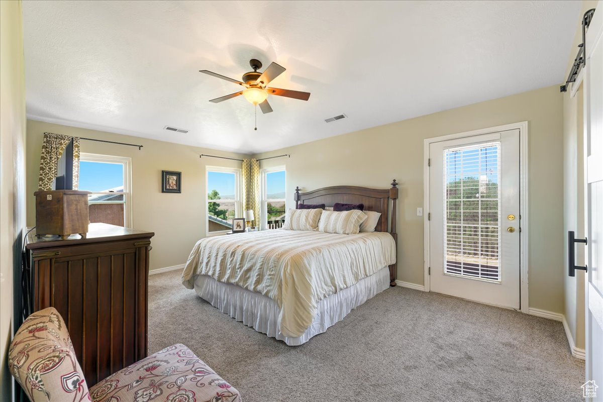 Bedroom featuring carpet floors, ceiling fan, and access to exterior