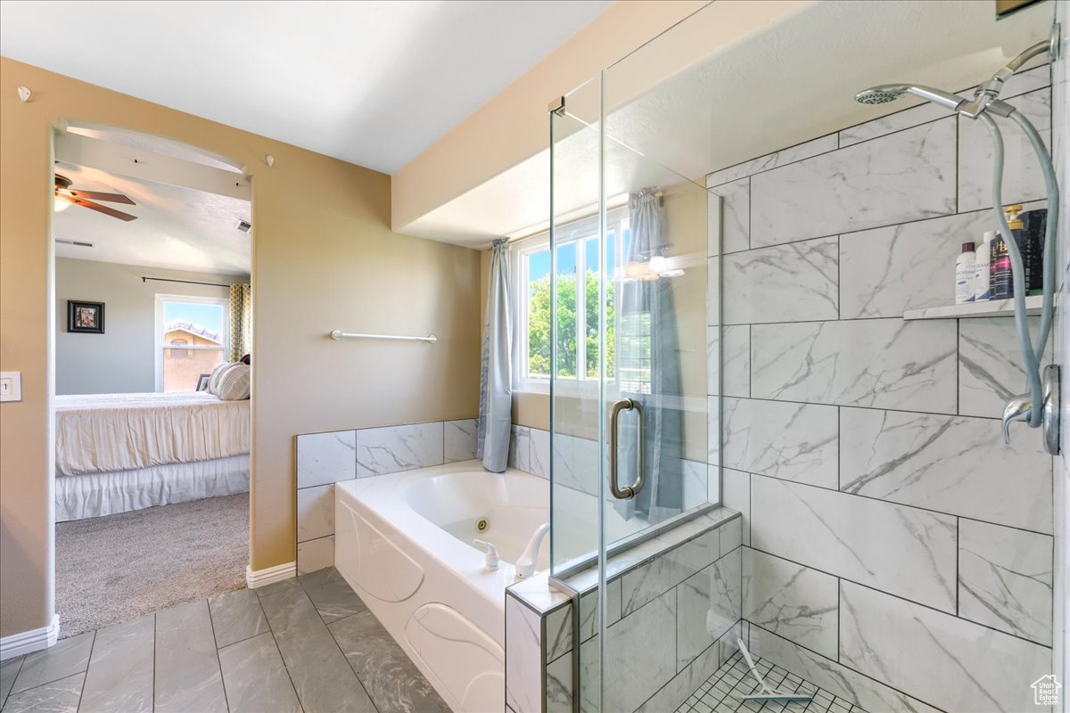 Bathroom with shower with separate bathtub, tile floors, and ceiling fan