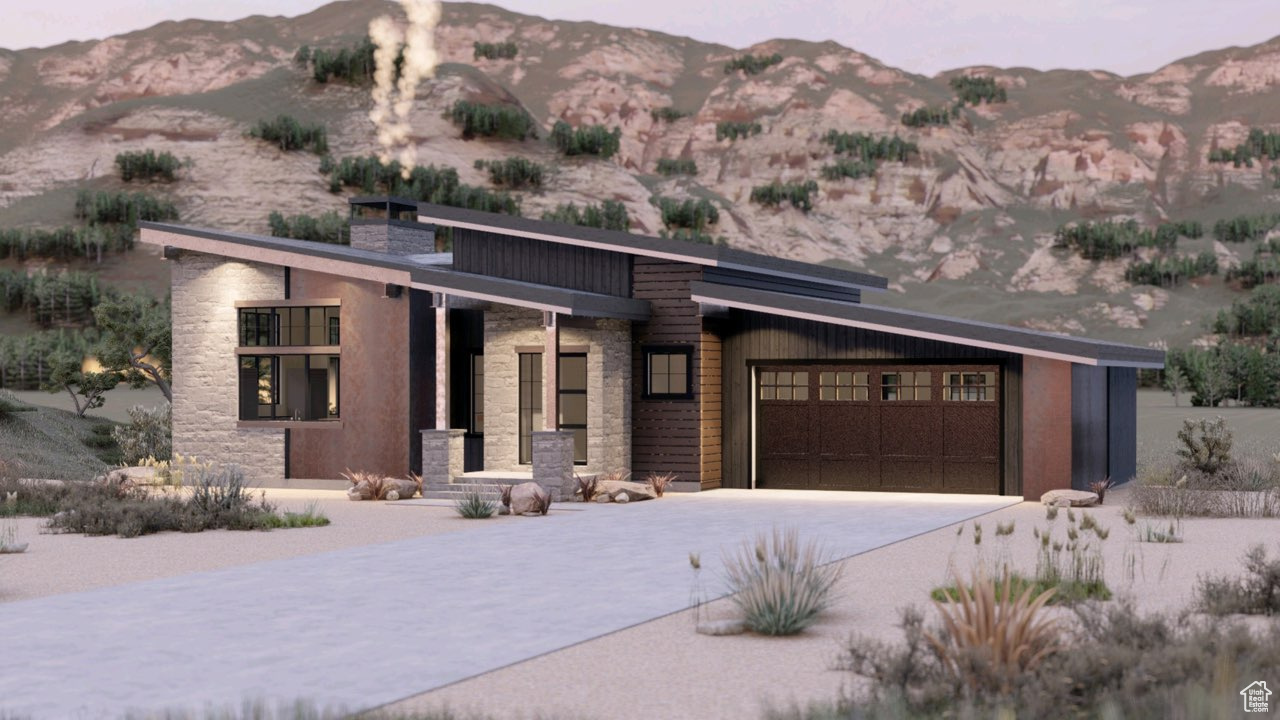 Modern home featuring a mountain view, a garage, and a balcony