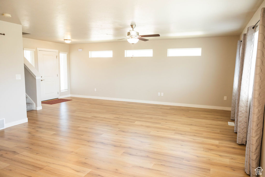 Front room with ceiling fan and light laminate flooring