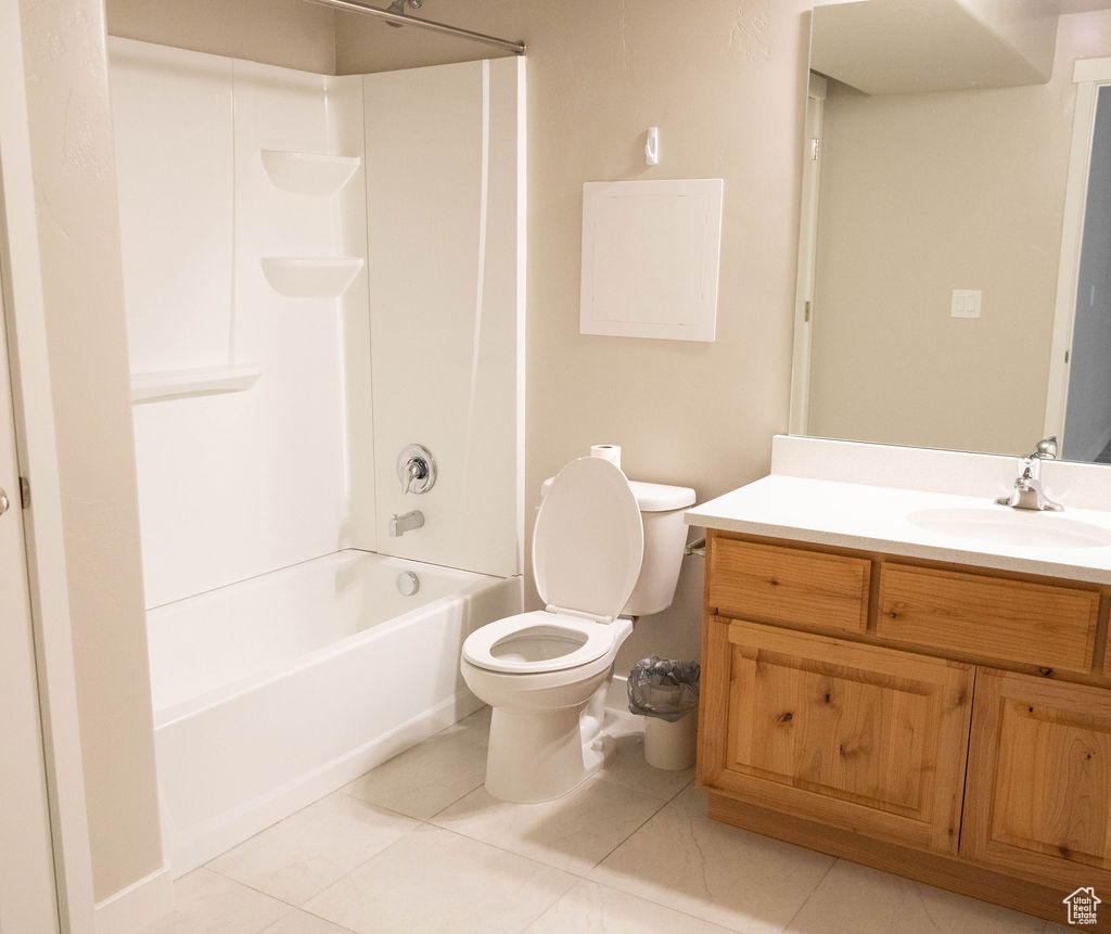 Full bathroom with tile floors and shower/bathtub combination in basement