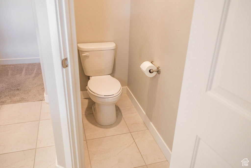 Master bathroom toilet with tile floors