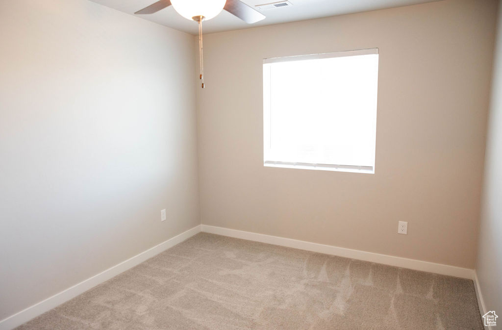 Bedroom 3 with ceiling fan and carpet flooring
