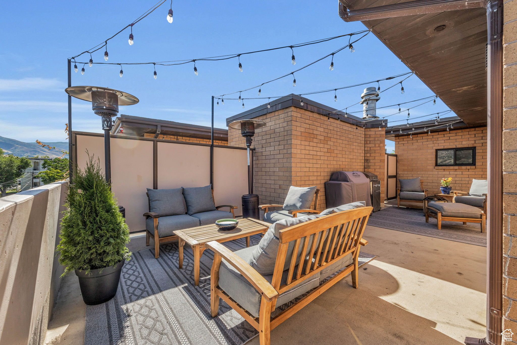 700 Sq Ft private terrace with an outdoor living space with cafe lights, and fantastic views of the city and sunset