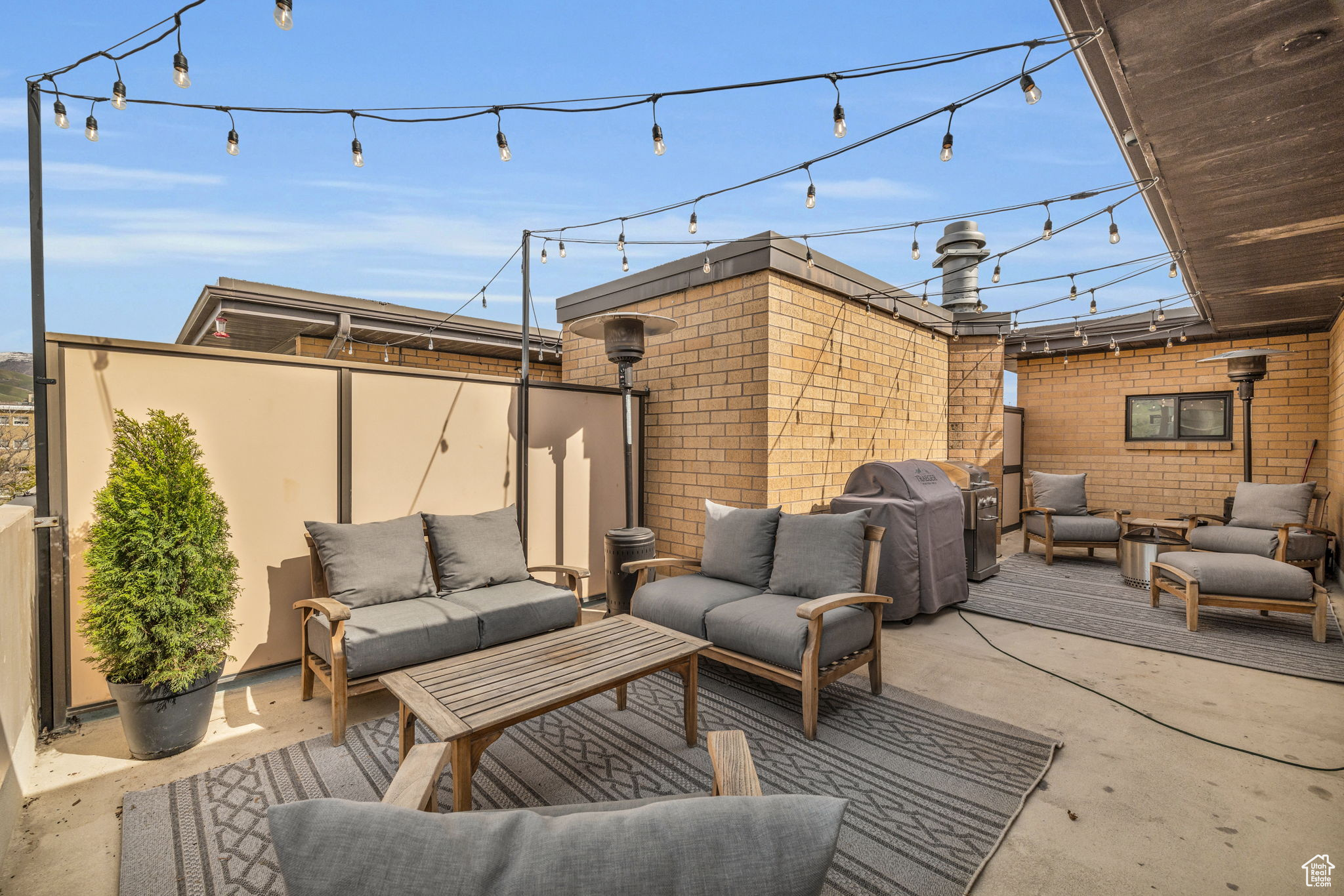 700 Sq Ft open-air private terrace with an outdoor living space with cafe lights, and fantastic views of the city and sunset