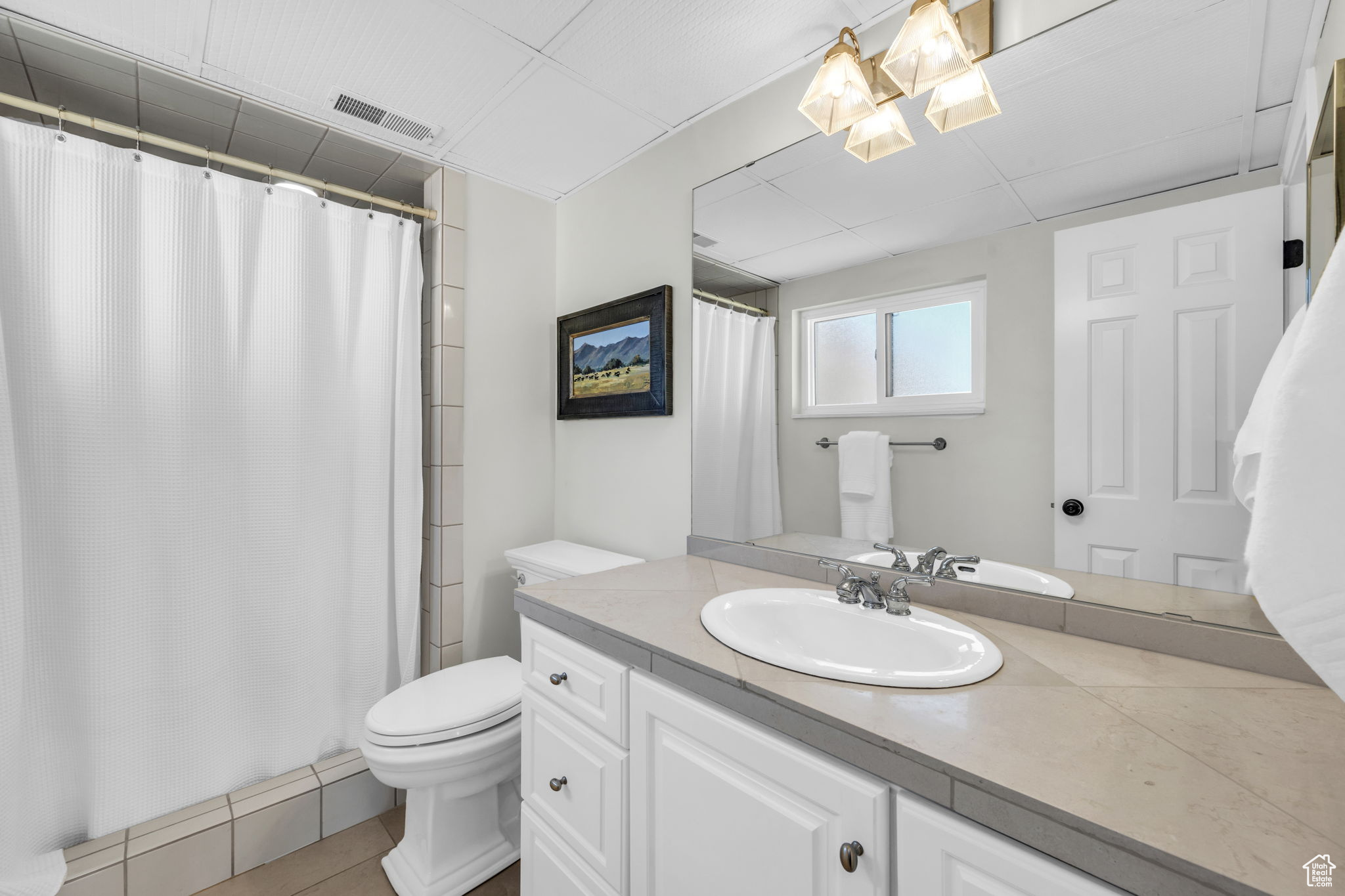 Bathroom featuring oversized vanity, tile floors, toilet, and a combo tub-showr