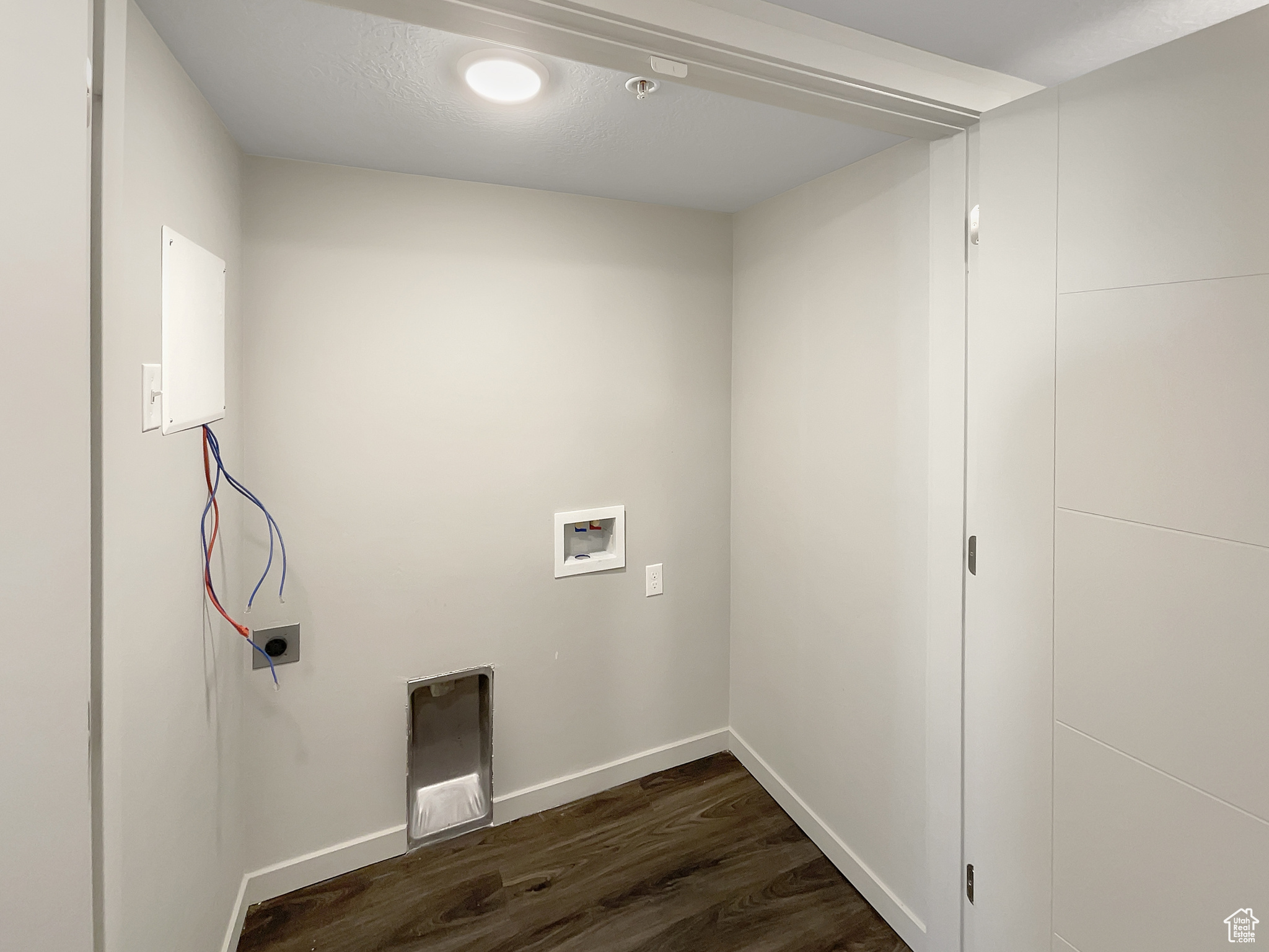 Laundry area with dark hardwood / wood-style flooring, hookup for an electric dryer, and hookup for a washing machine