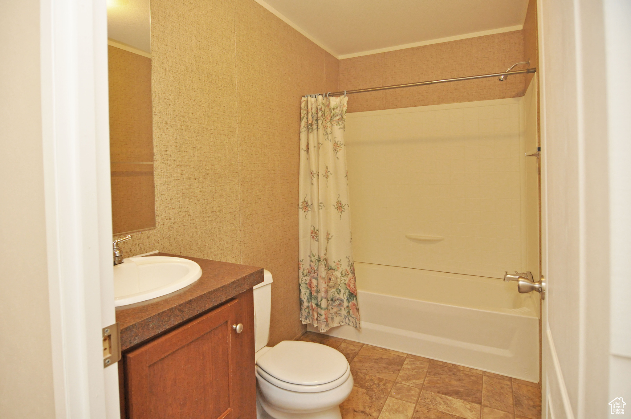 Full bathroom featuring tile flooring, shower / tub combo, crown molding, toilet, and vanity